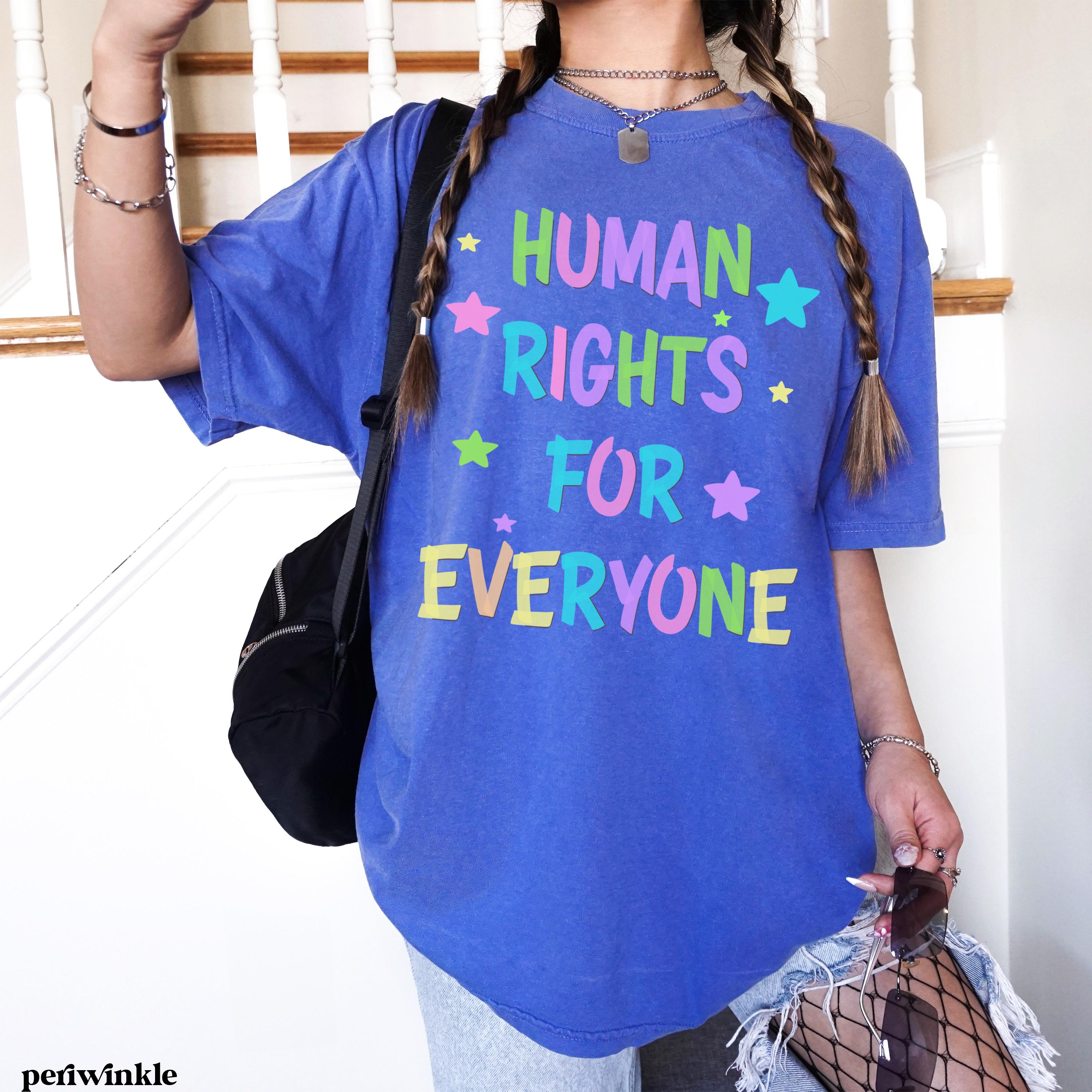 Blue t-shirt with "Human Rights For Everyone" in colorful block letters and stars.