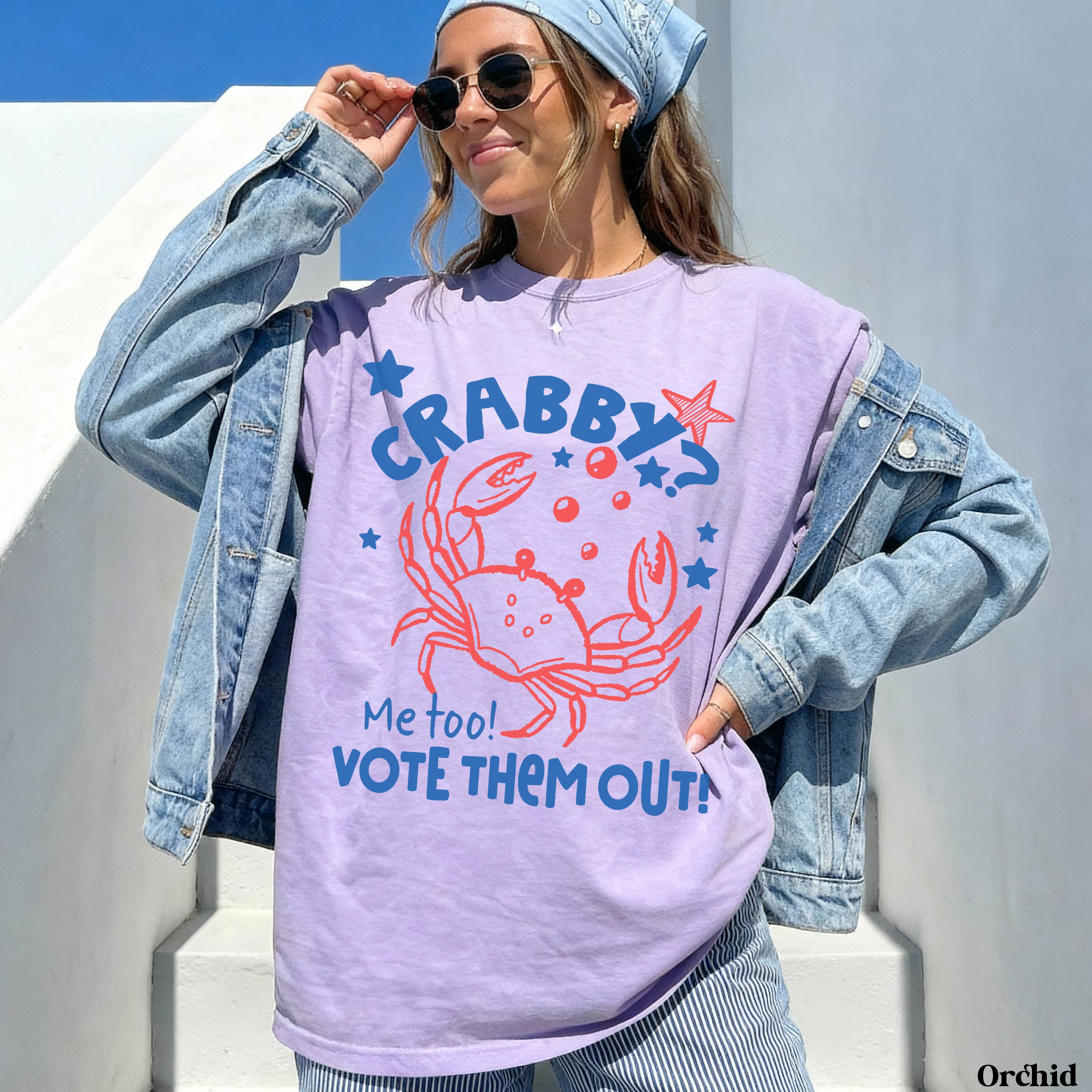 Crabby crab graphic on light purple t-shirt with "Vote them out!" text.