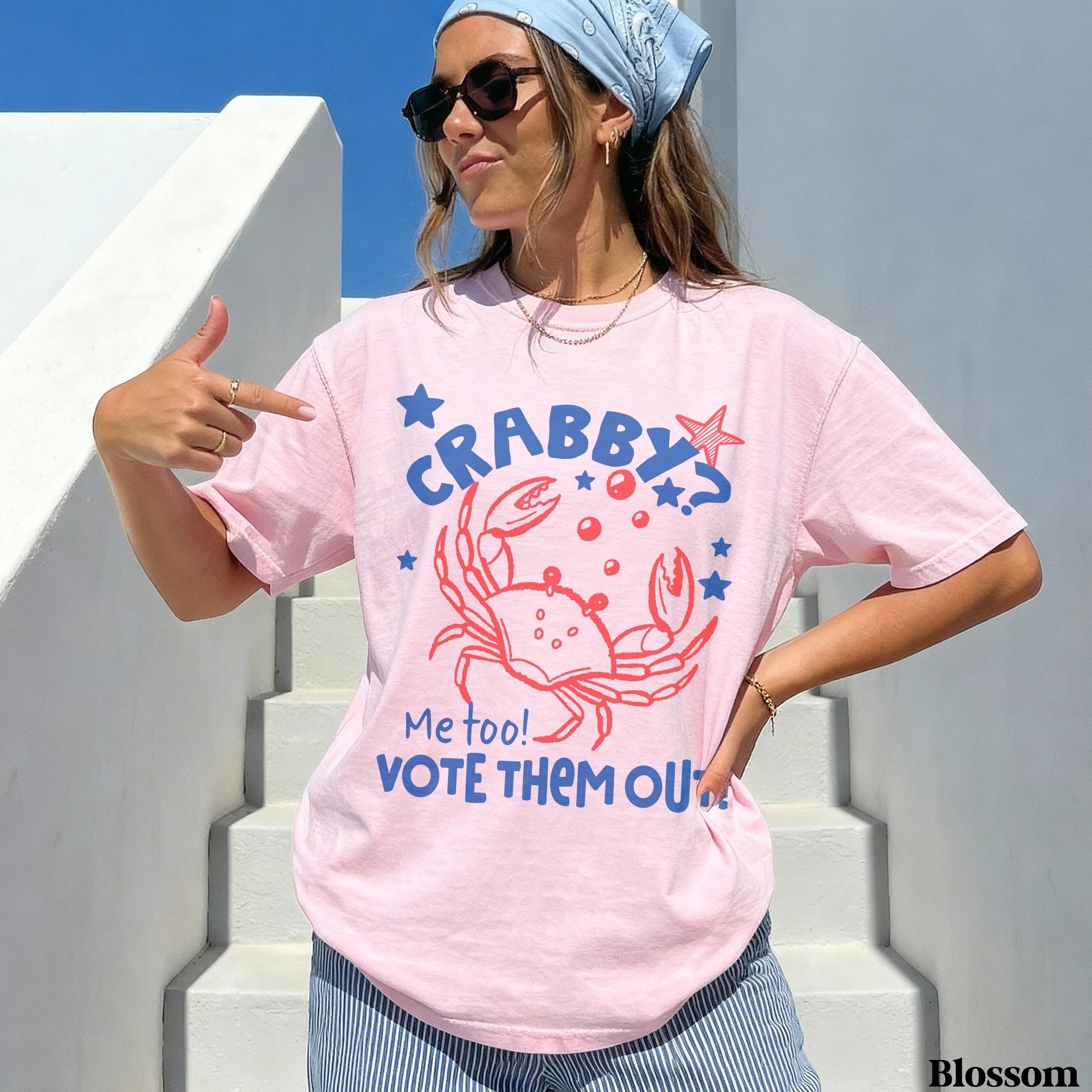 Pink t-shirt with "CRABBY? ME TOO! VOTE THEM OUT!" and crab graphic.