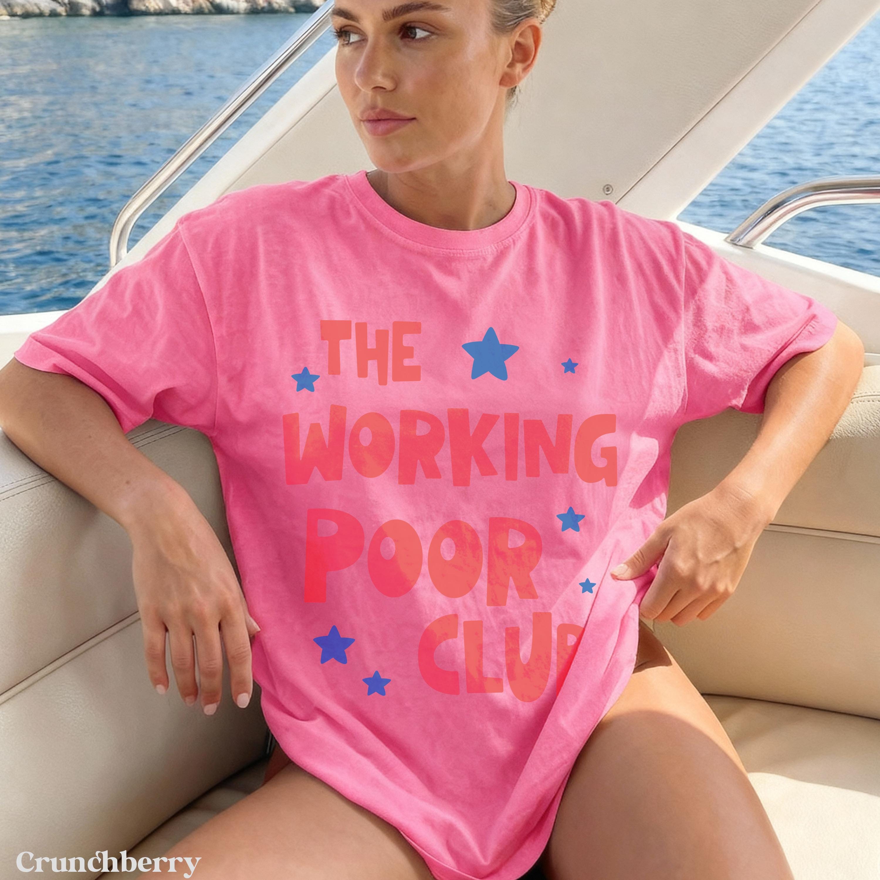 Woman in pink t-shirt with "THE WORKING POOR CLUB" text and blue stars.