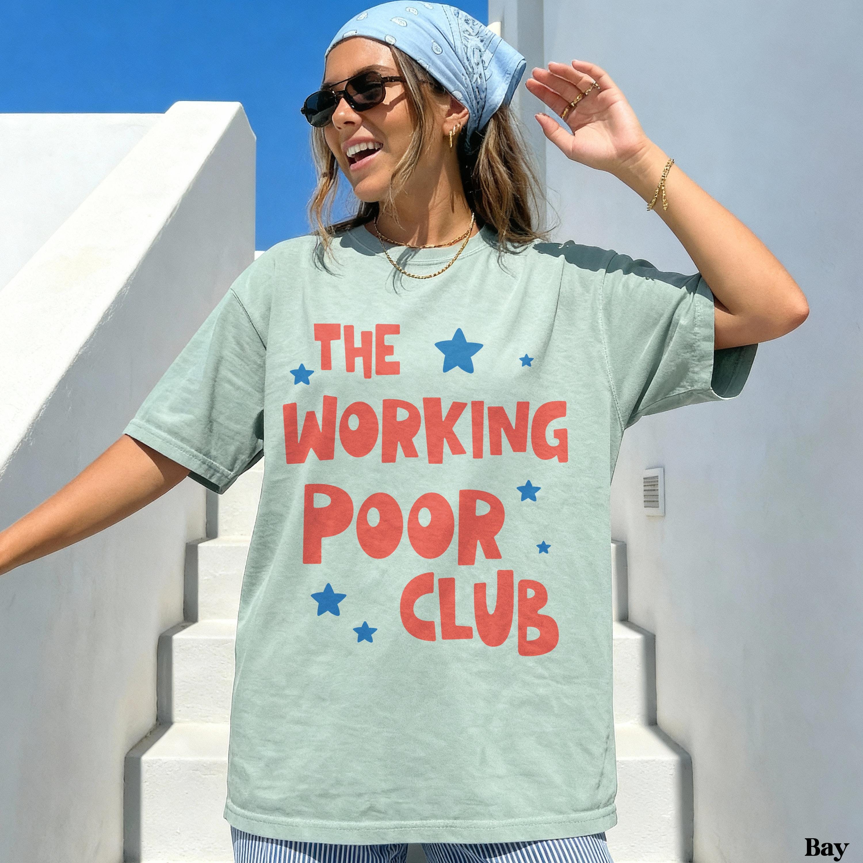 Woman in light green t-shirt with red text "THE WORKING POOR CLUB" and blue stars.