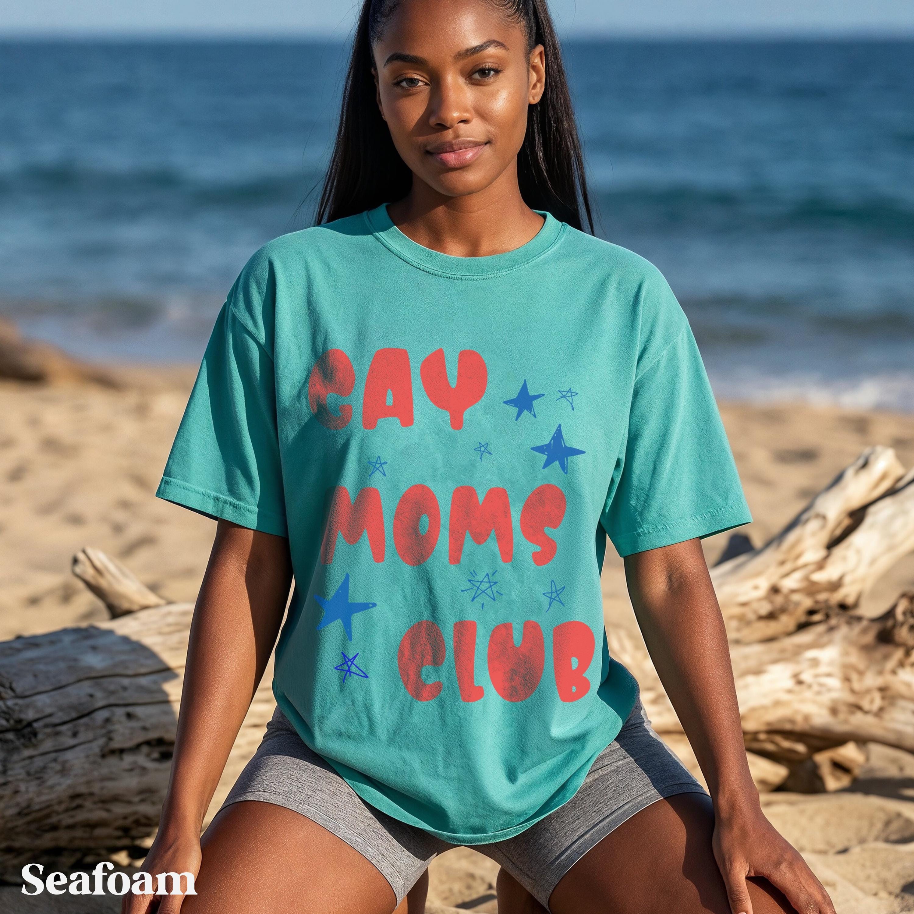 Teal t-shirt with "GAY MOMS CLUB" text and red stars.
