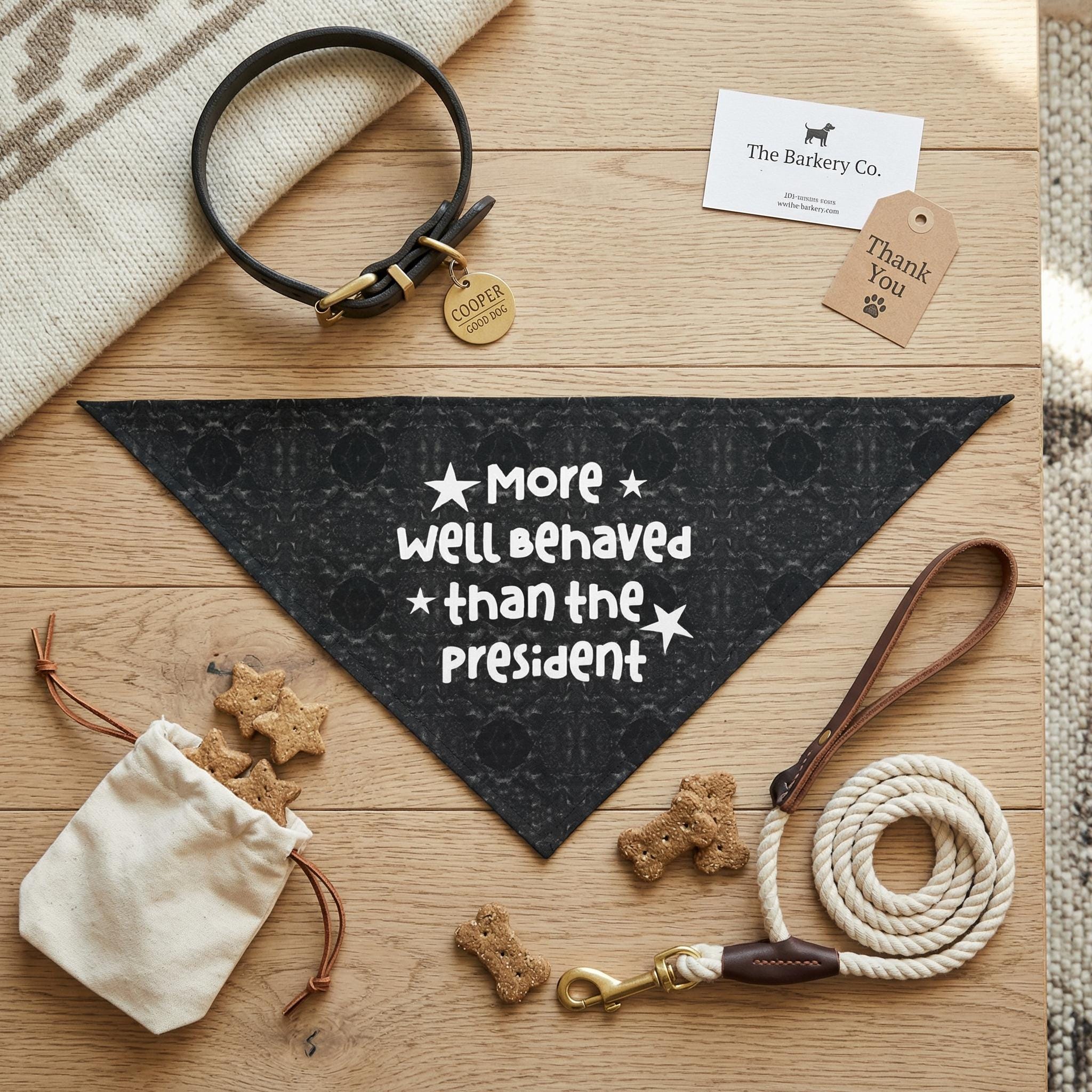 Dog bandana with "More well Behaved than the President" text, collar, leash, and treats.