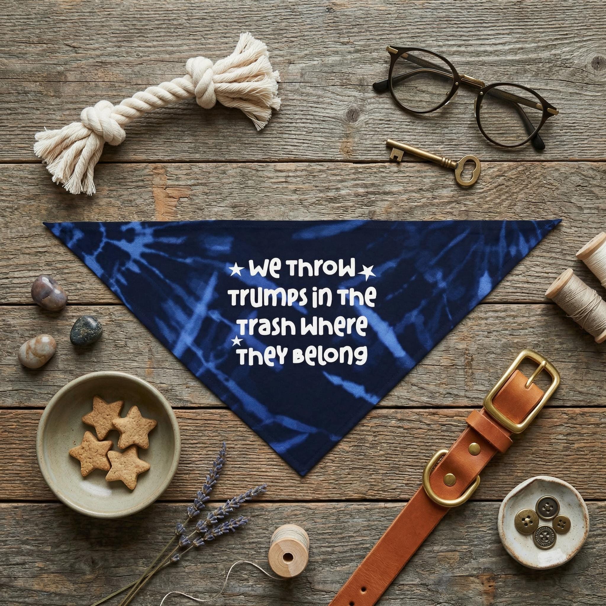 Blue tie-dye bandana with white text "WE THROW TRUMPS IN THE TRASH WHERE THEY BELONG".