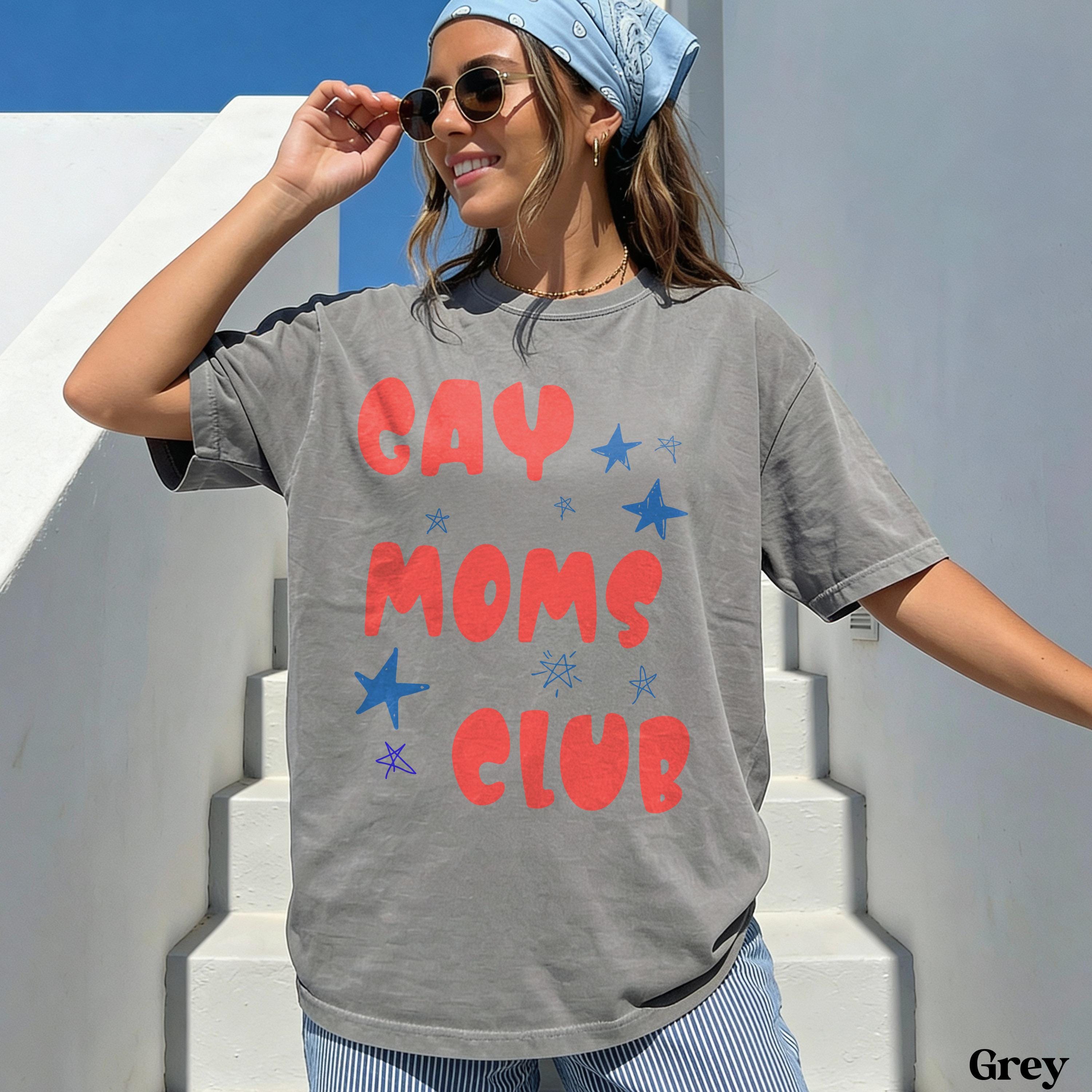 Grey t-shirt with red text "GAY MOMS CLUB" and blue stars.