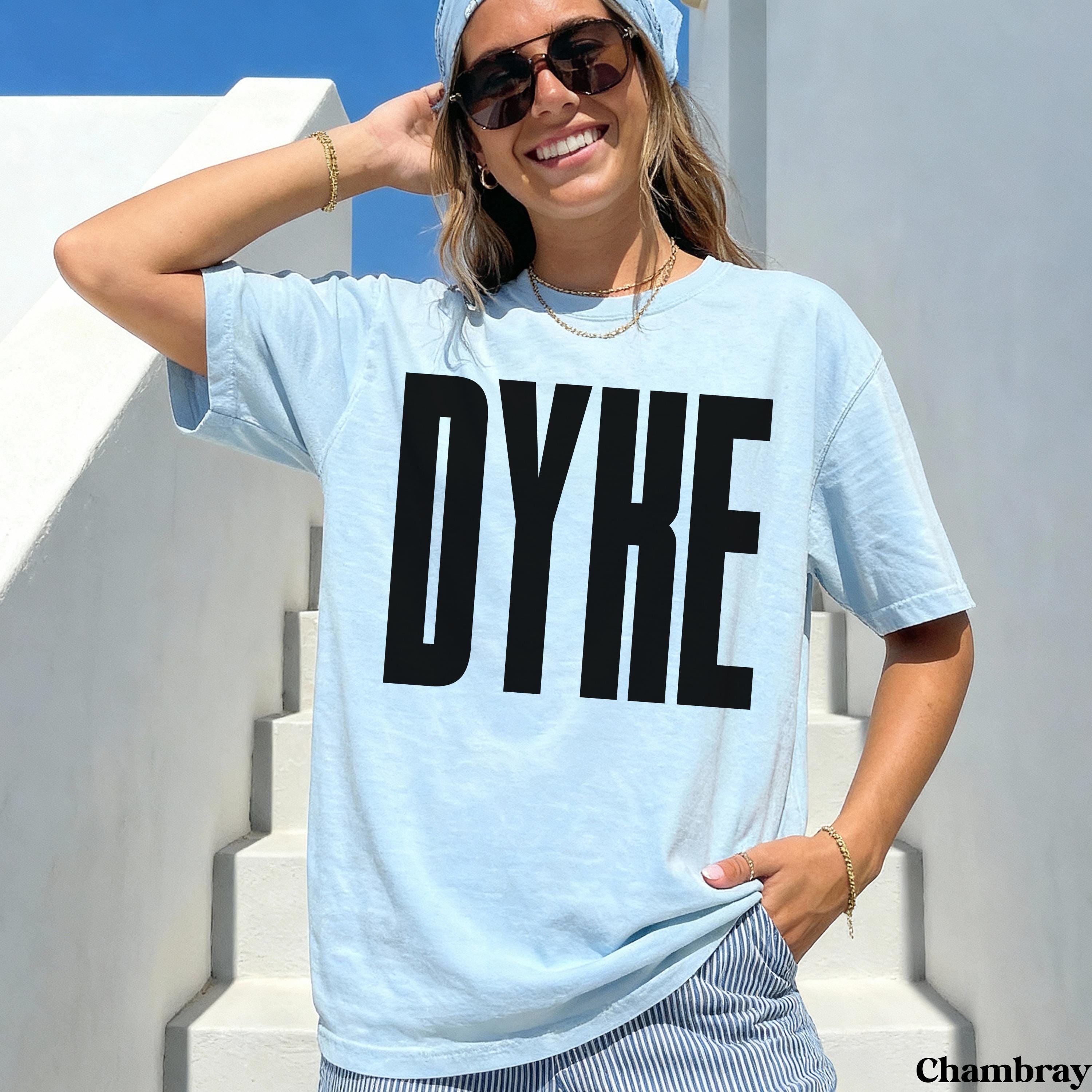 Light blue t-shirt with black "DYKE" text and "Chambray" label.