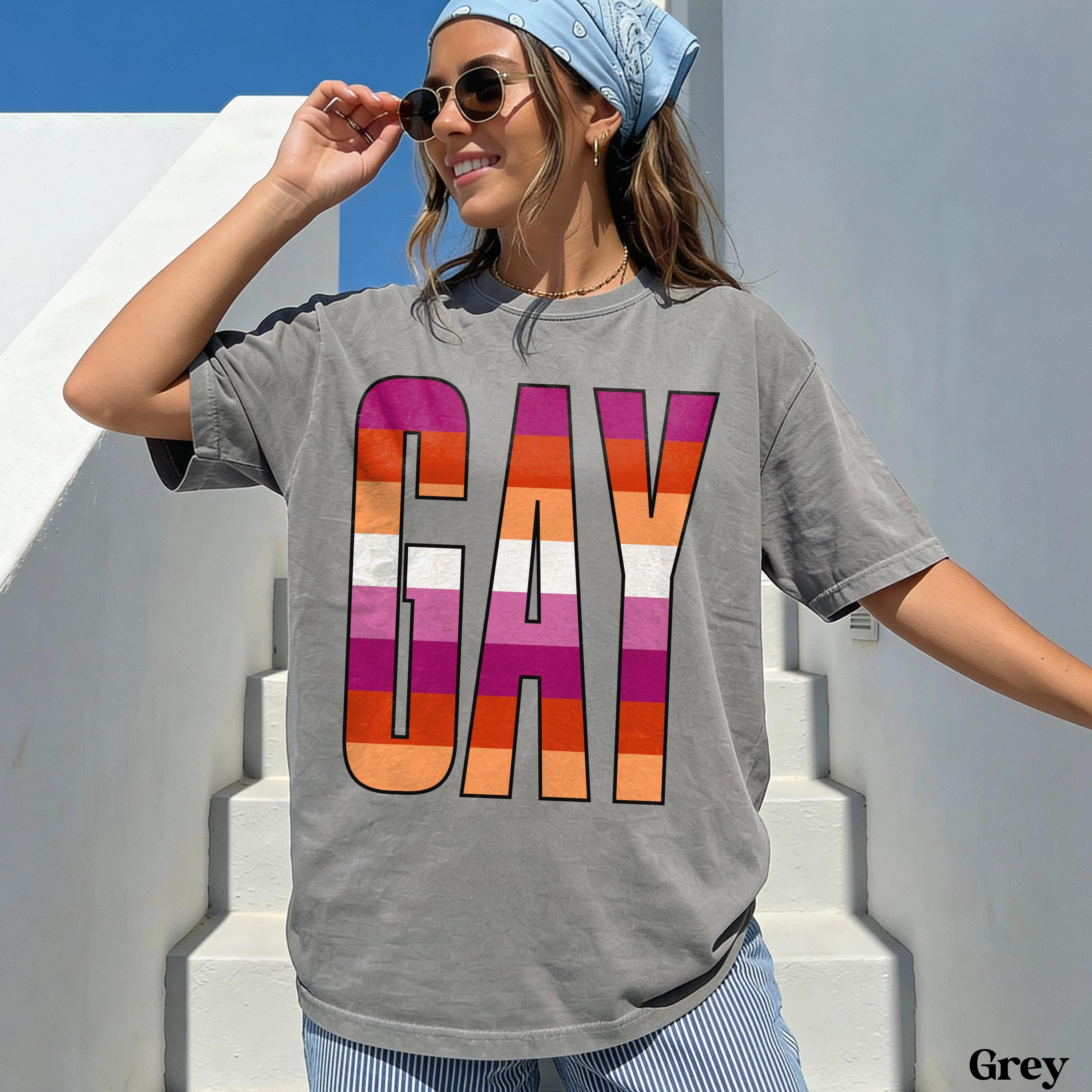 Gray t-shirt with "GAY" in rainbow stripe lettering.