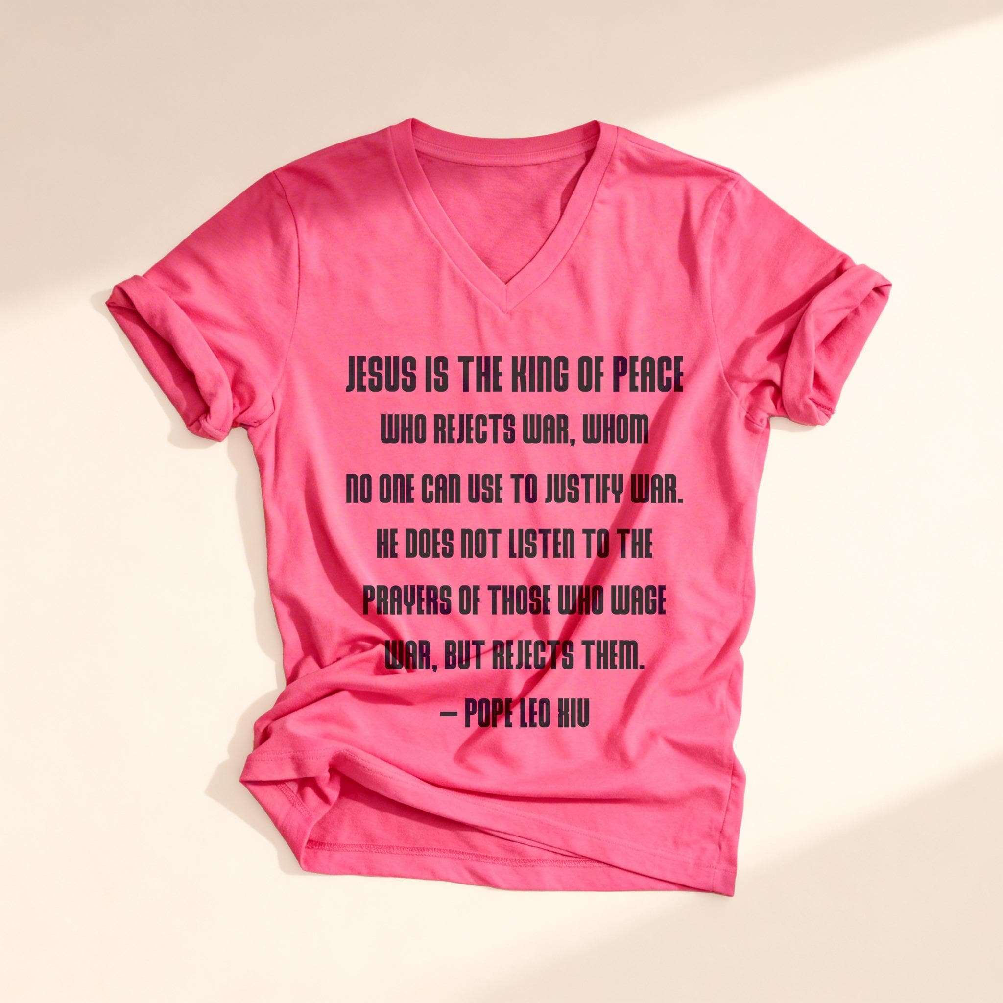 Pink t-shirt with black text quoting Pope Leo XI: "Jesus is the king of peace."