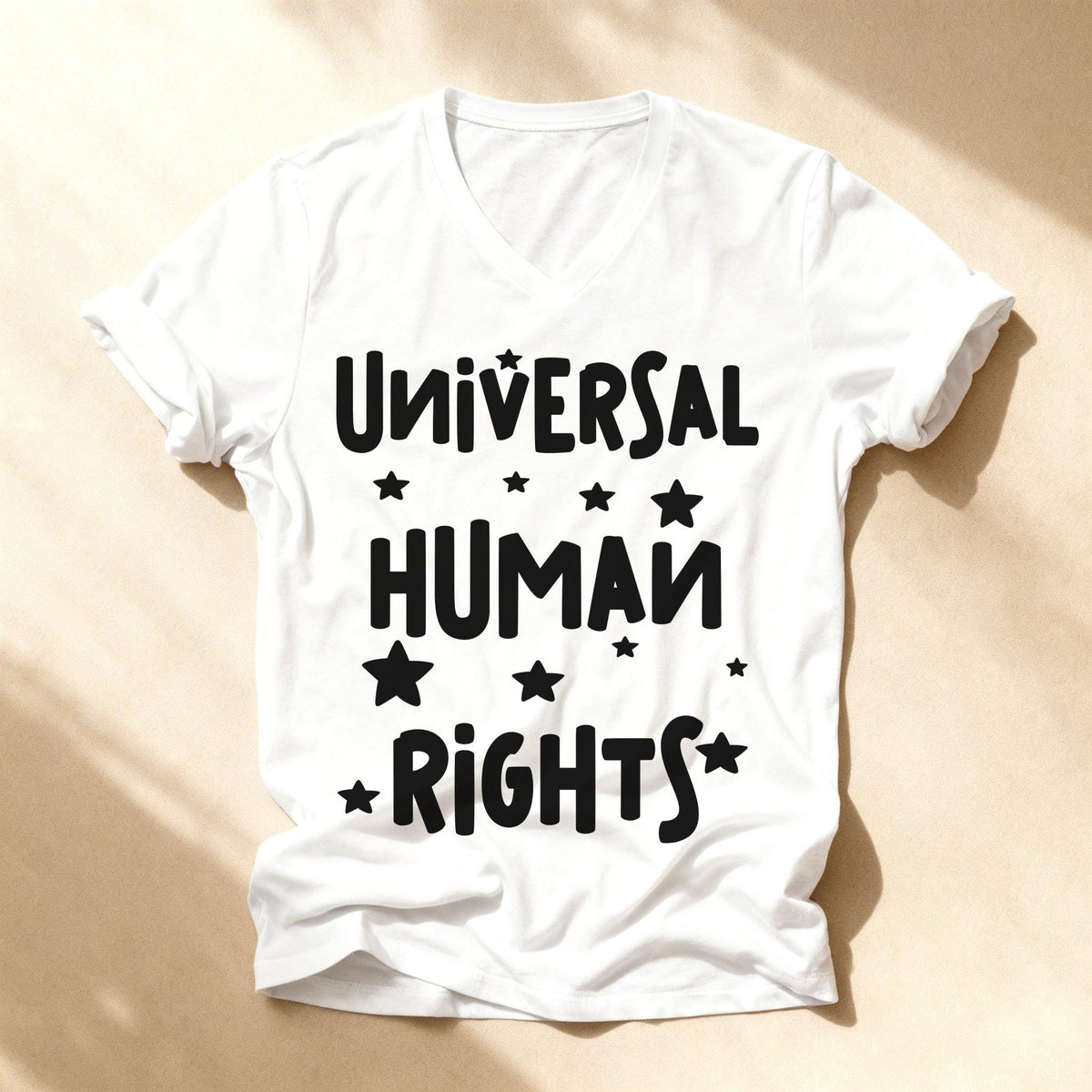 White v-neck t-shirt with black text "UNIVERSAL HUMAN RIGHTS" and stars.
