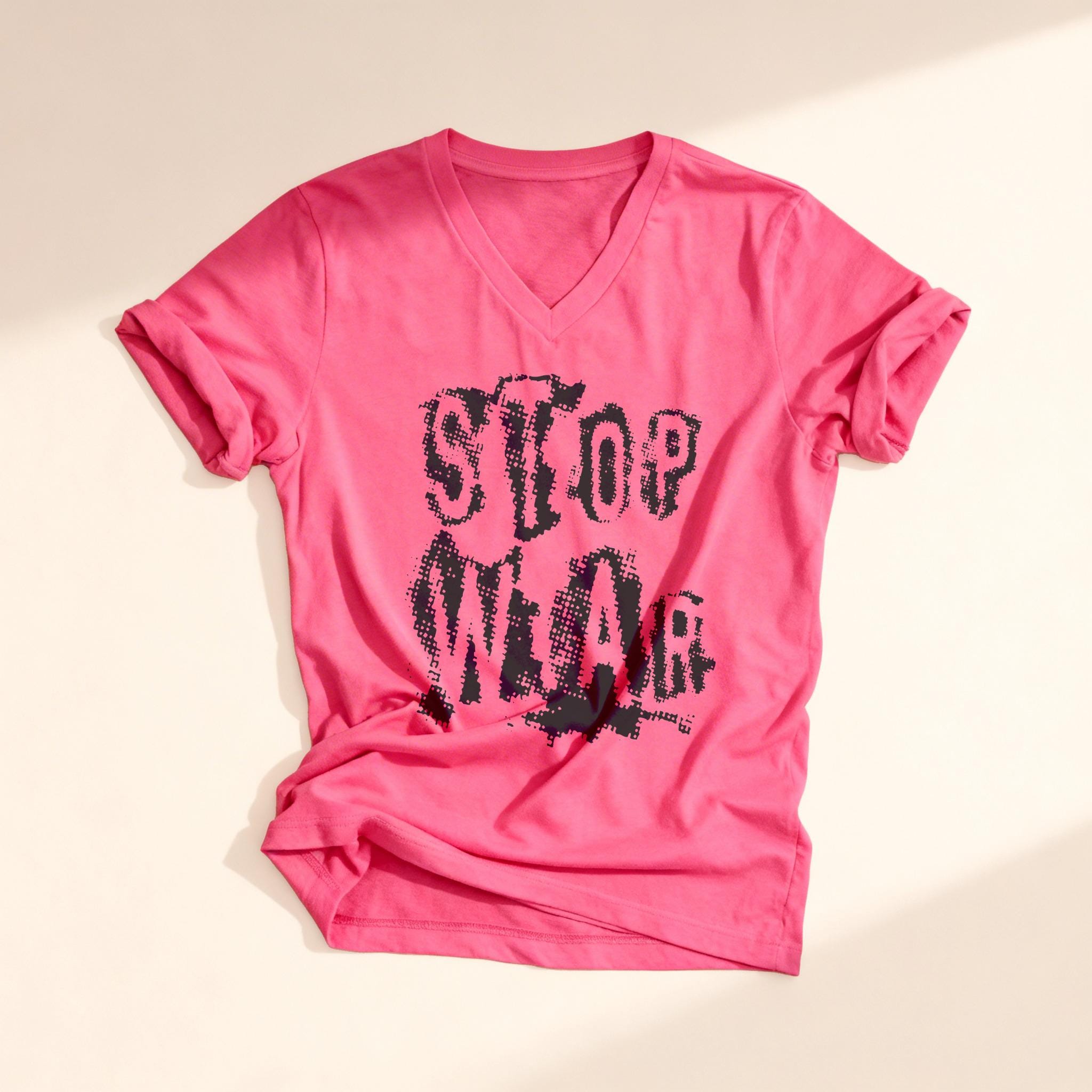 Pink v-neck t-shirt with distressed "STOP WEAR" graphic text.