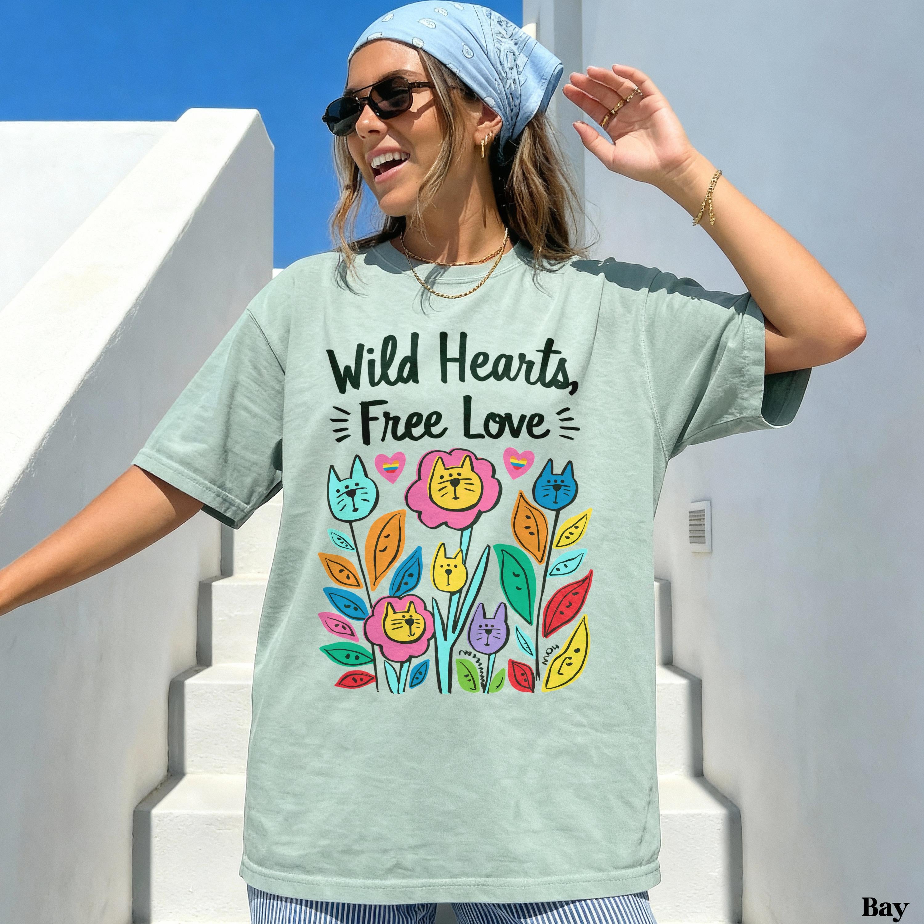 Mint green t-shirt with colorful floral and cat graphic and "Wild Hearts, Free Love" text.