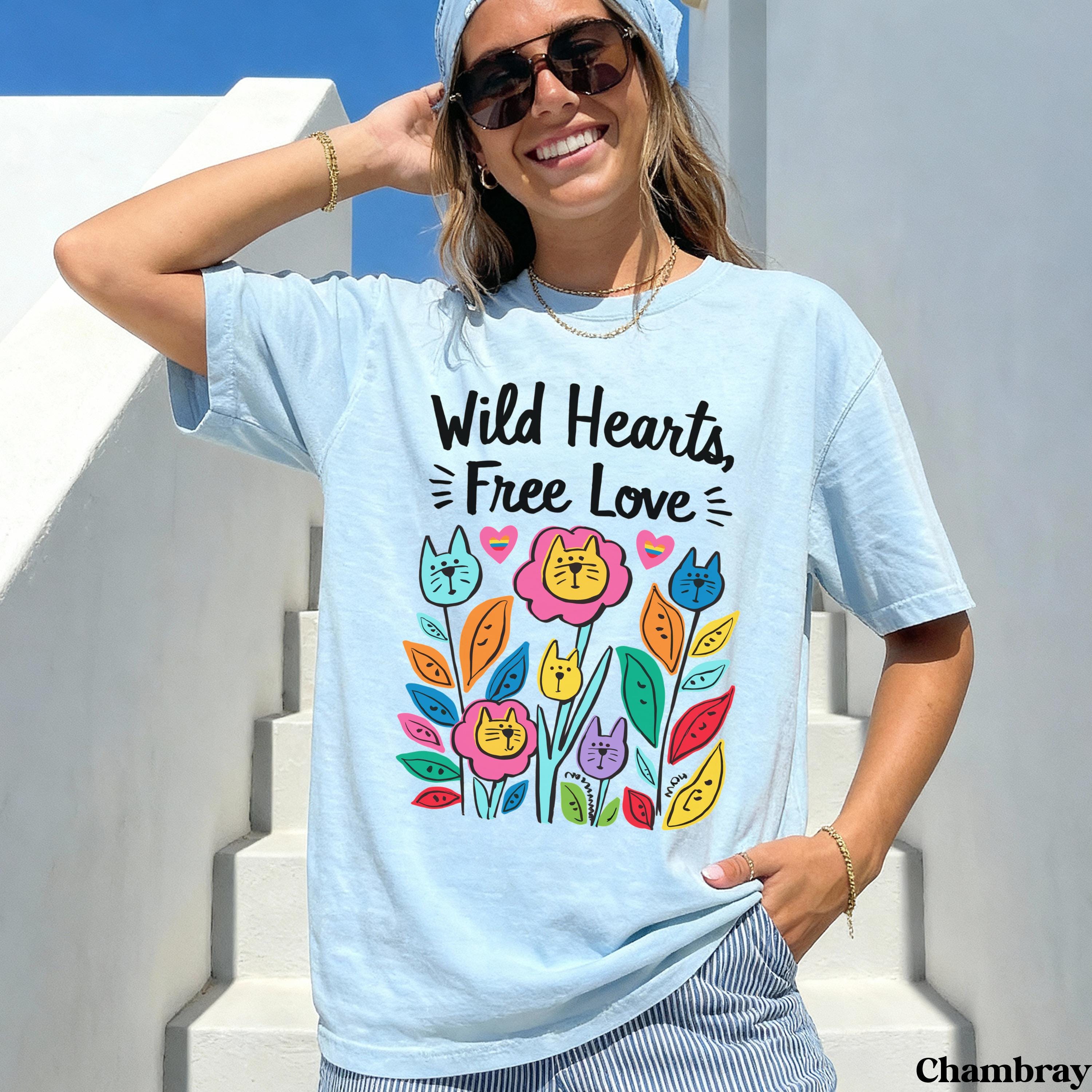 Light blue t-shirt with "Wild Hearts, Free Love" text and colorful floral cat design.