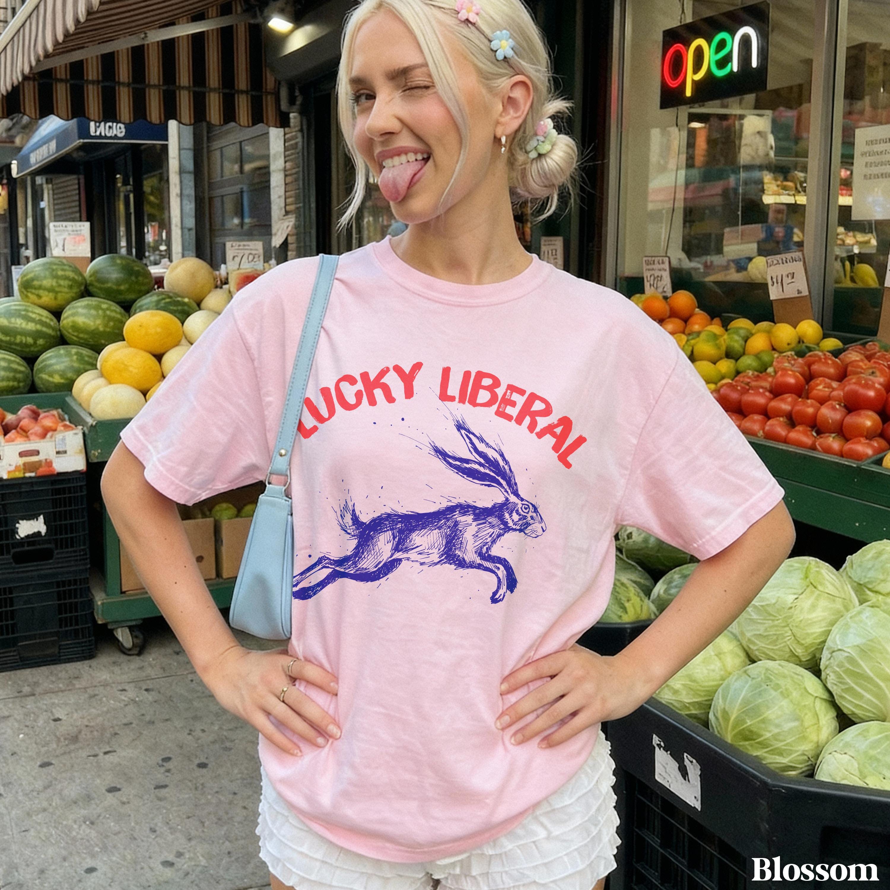 Pink t-shirt with blue rabbit graphic and "LUCKY LIBERAL" text.