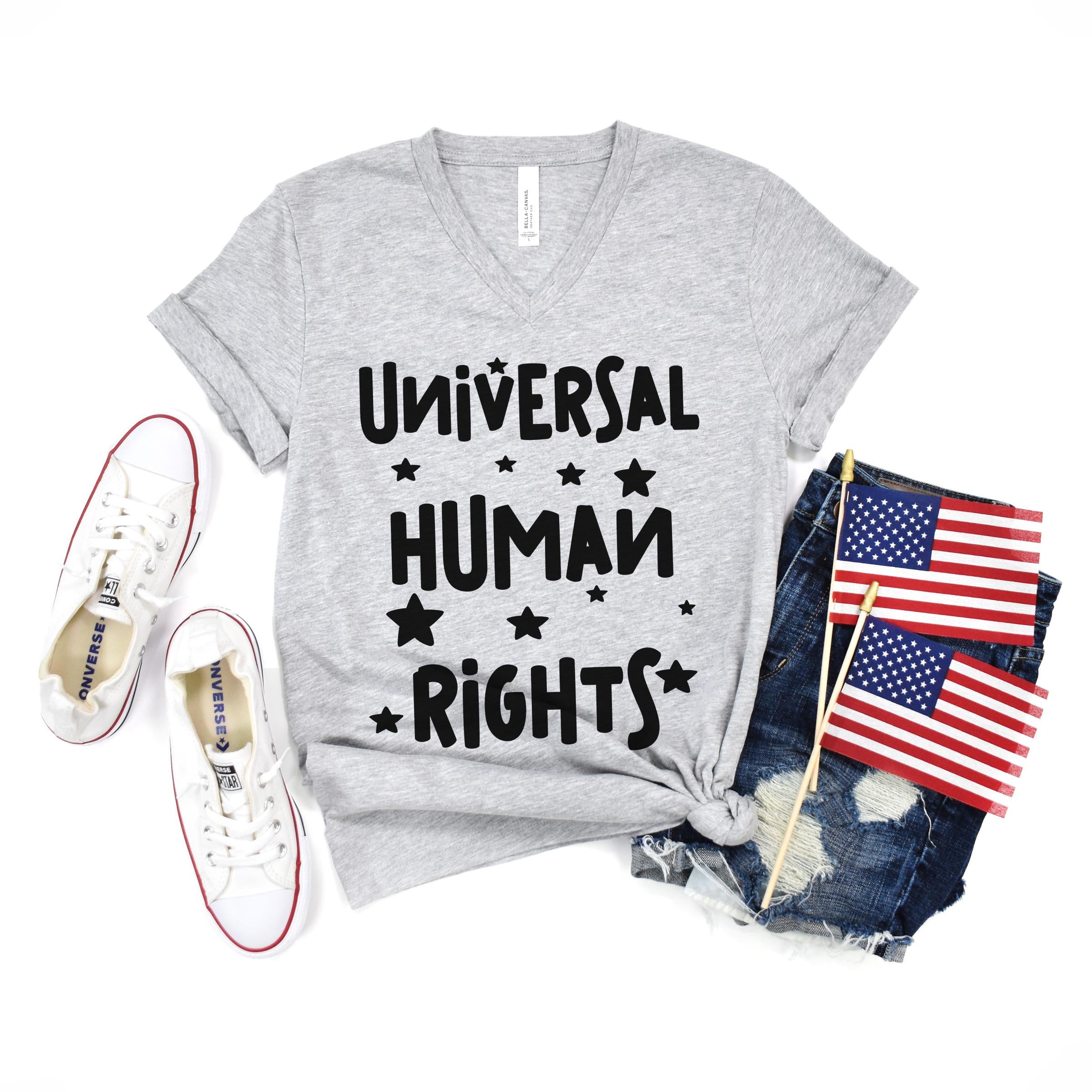 Grey t-shirt with "UNIVERSAL HUMAN RIGHTS" text and stars, paired with denim shorts and American flags.