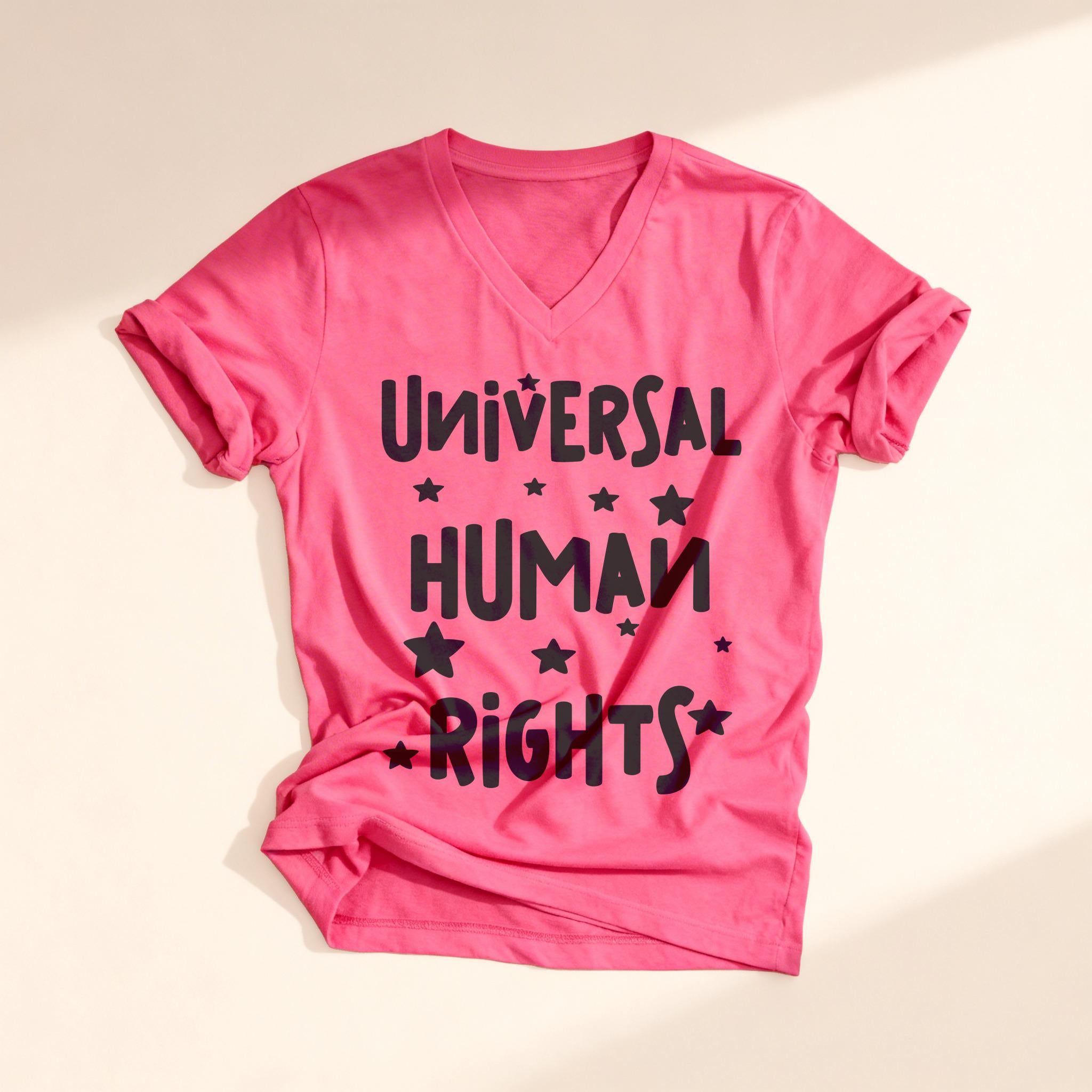 Pink t-shirt with black text "Universal Human Rights" and stars.