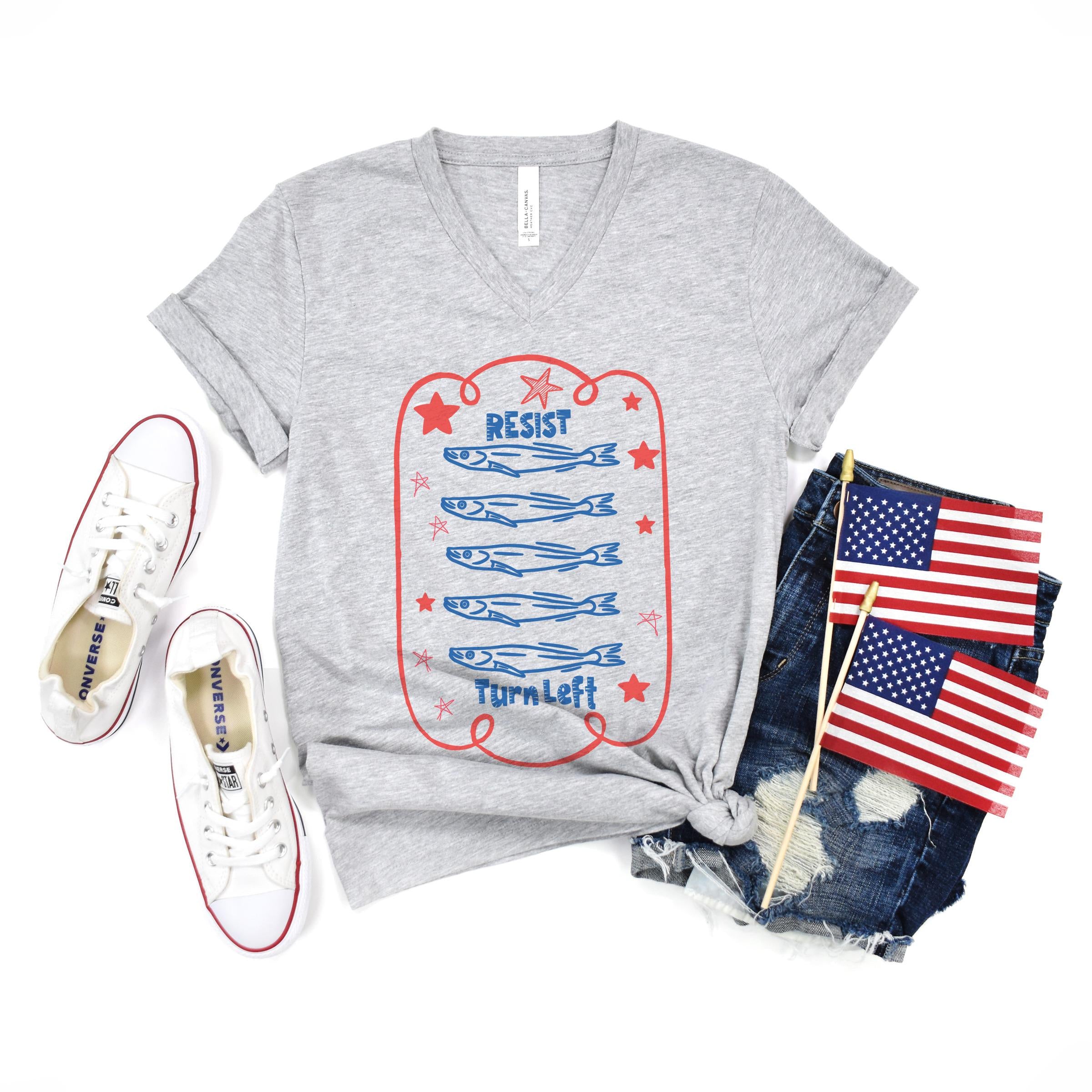 Gray t-shirt with "RESIST" and fish graphic, "Turn Left" text.