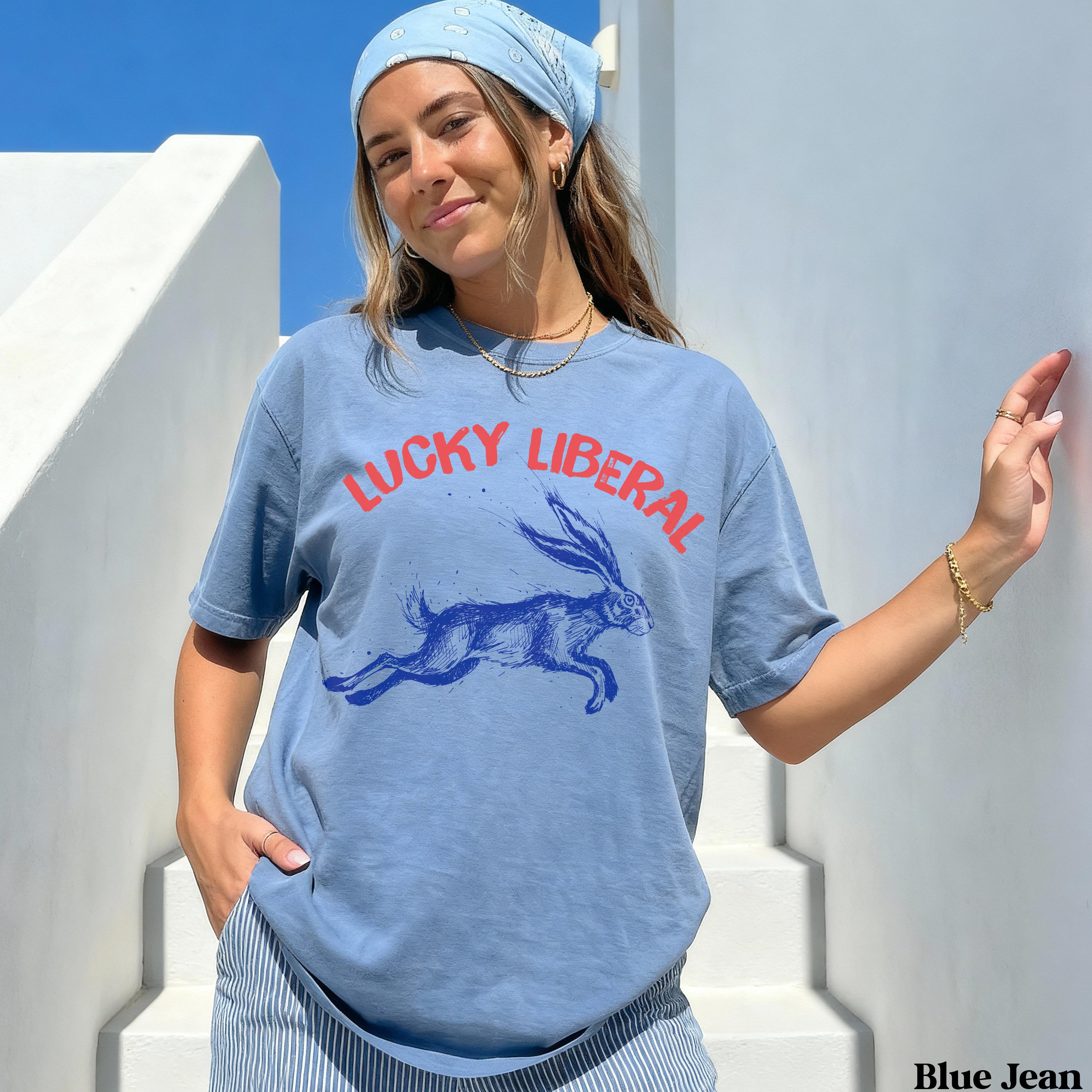 Blue t-shirt with "LUCKY LIBERAL" and running rabbit graphic.
