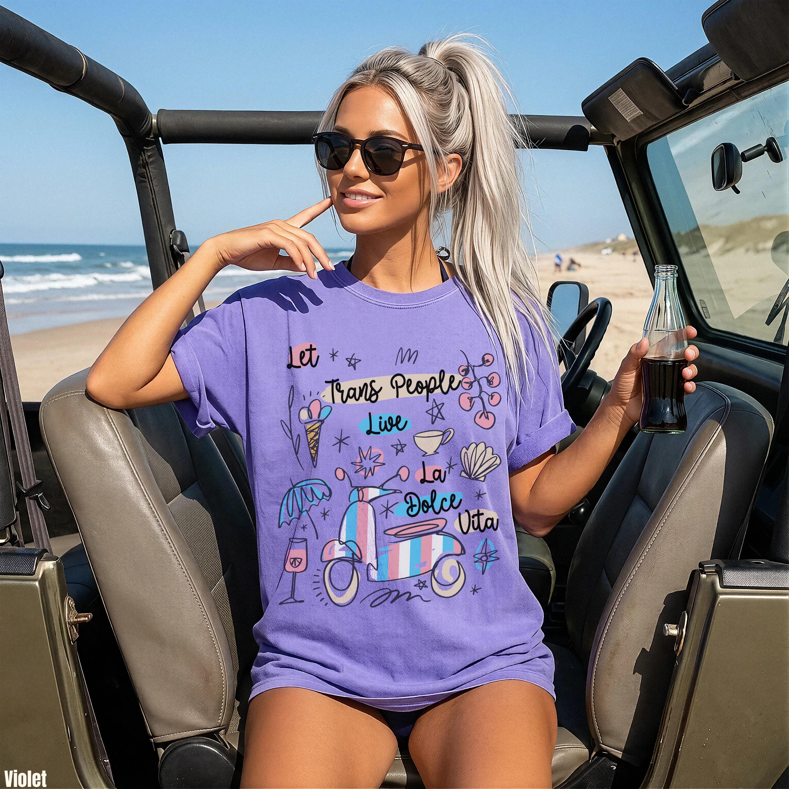 Purple t-shirt with scooter and text "Let Trans People Live La Dolce Vita"