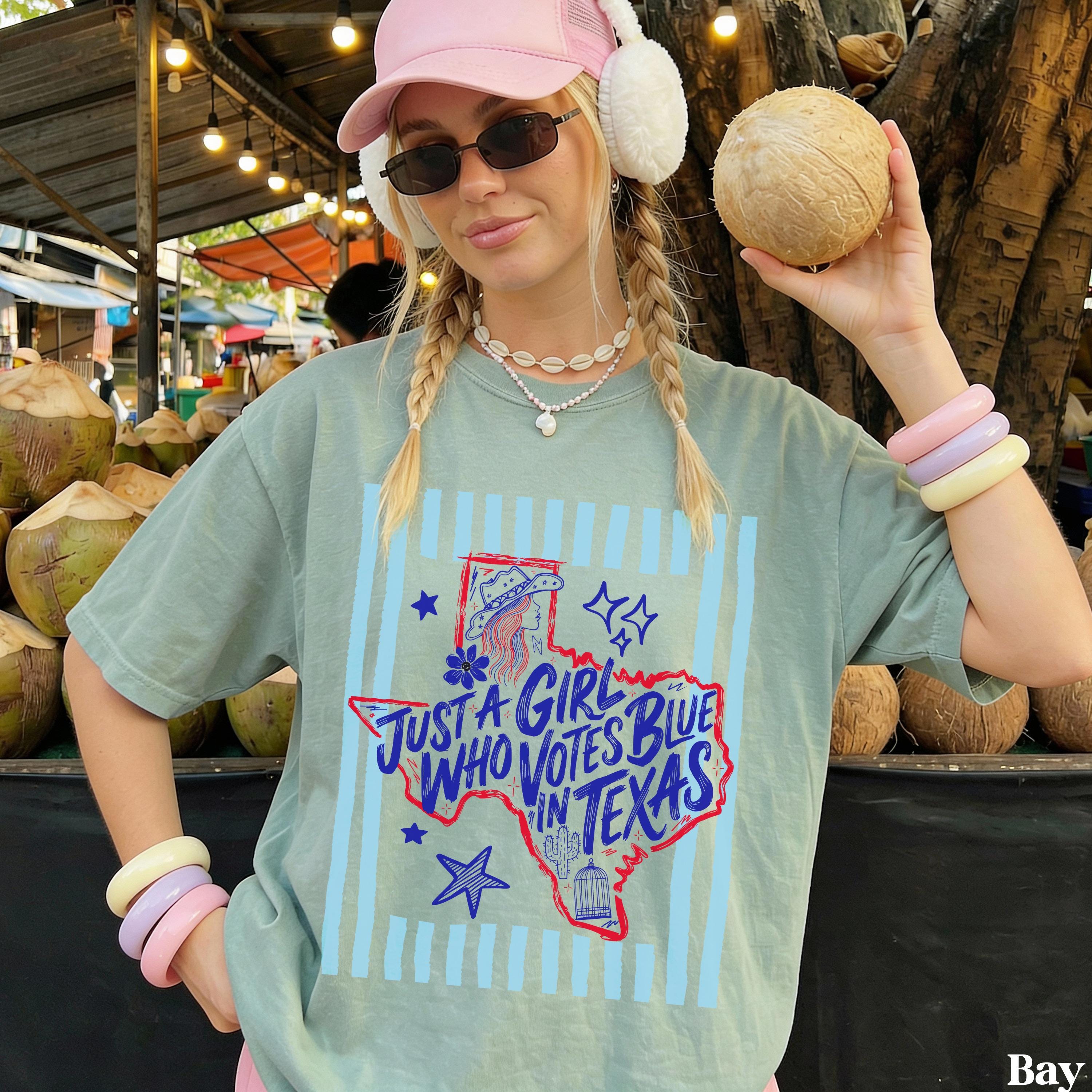 Woman wearing a t-shirt that says "Just a girl who votes blue in Texas".