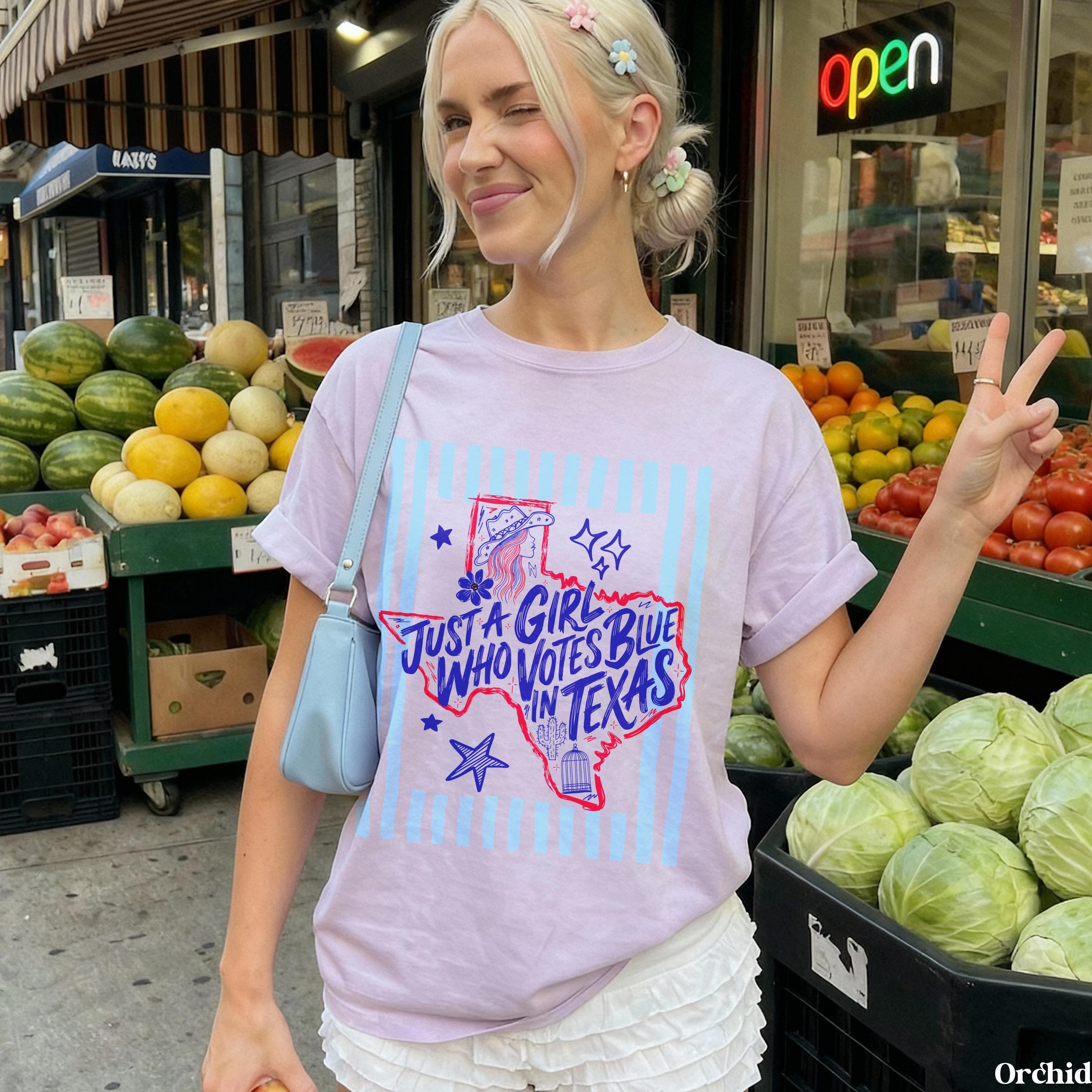 Light purple t-shirt with blue Texas graphic and text, "Just a girl who votes blue in Texas."