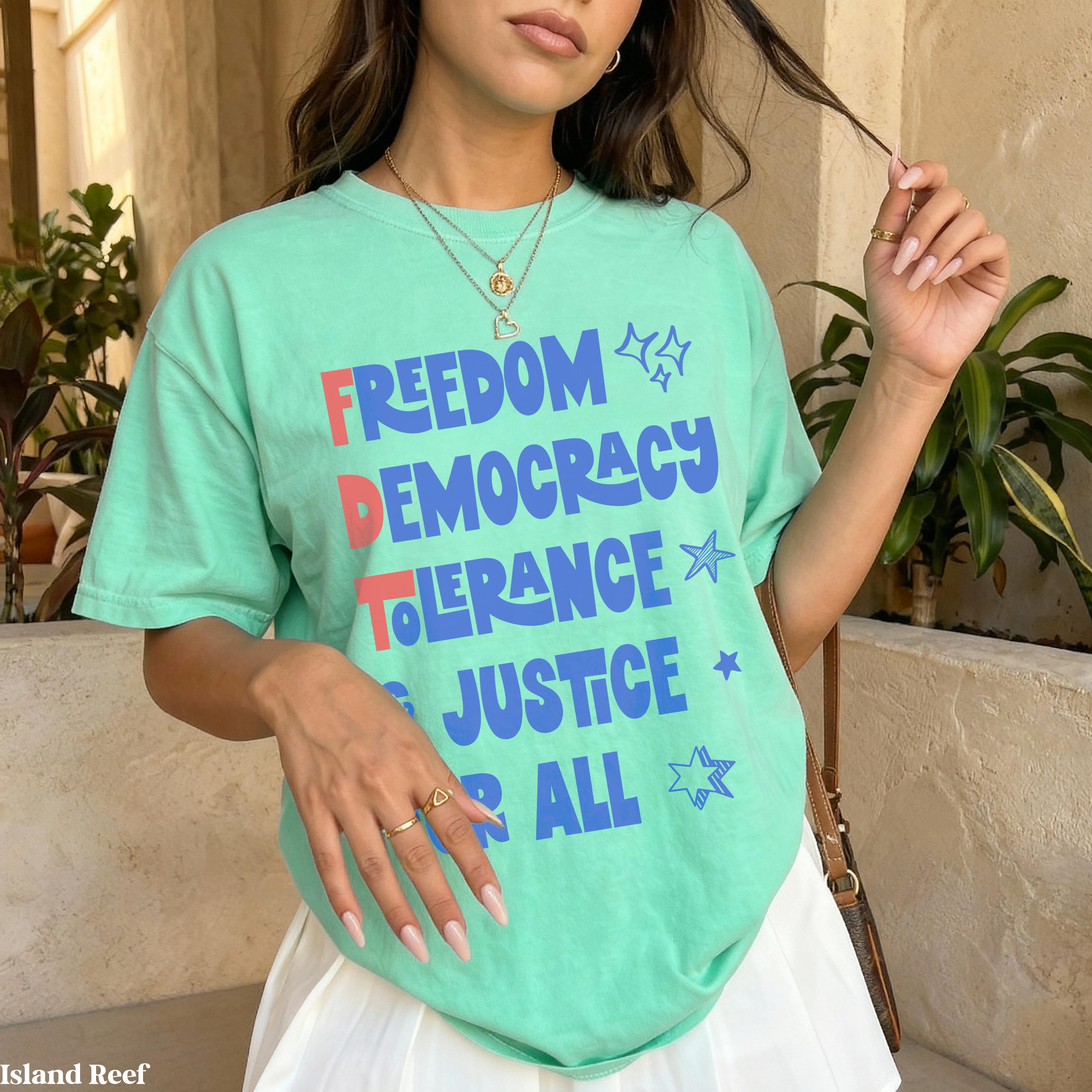 Mint green t-shirt with "Freedom Democracy Tolerance Justice All" text and stars.