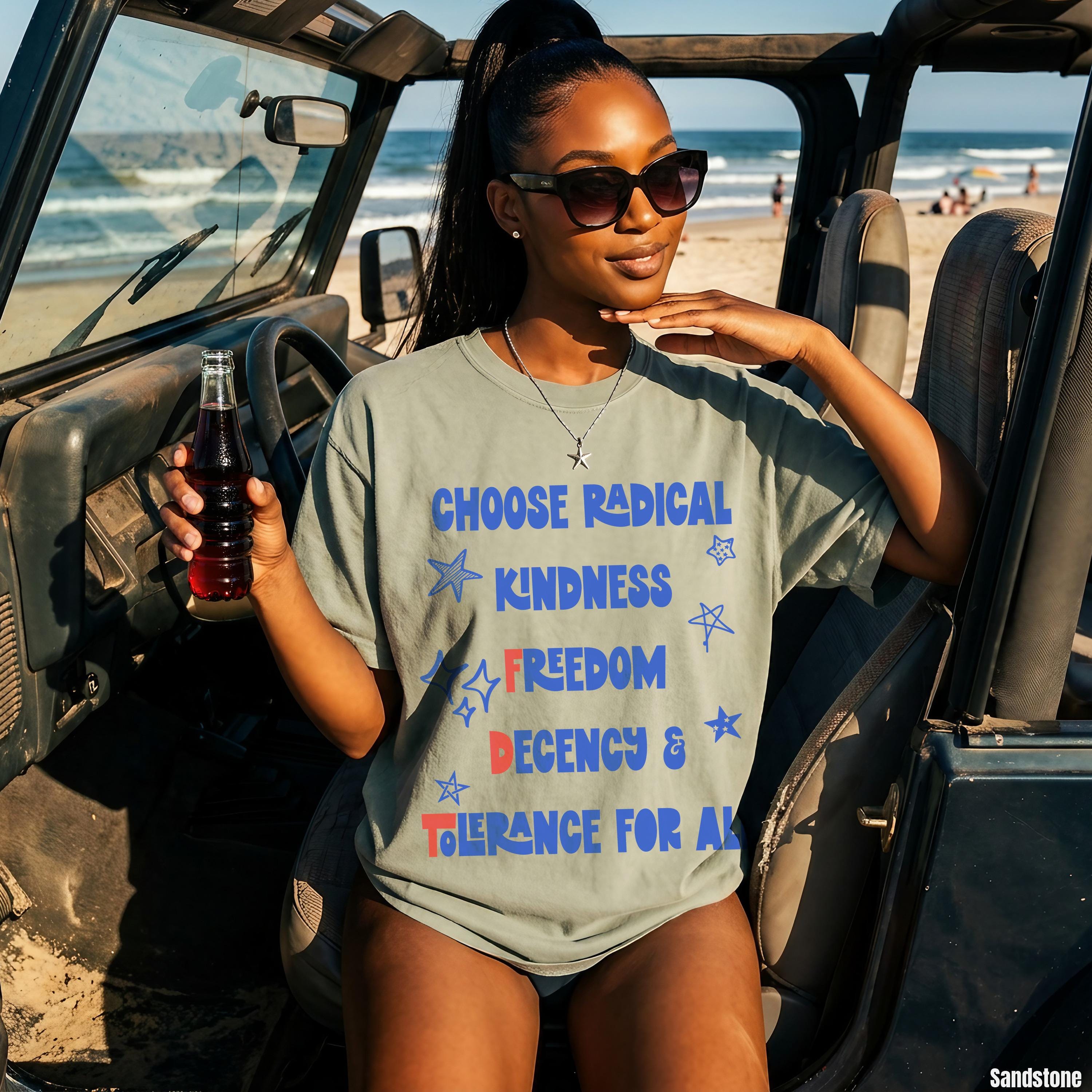 Woman in olive green t-shirt with "Choose Radical Kindness Freedom Decency For All" text.