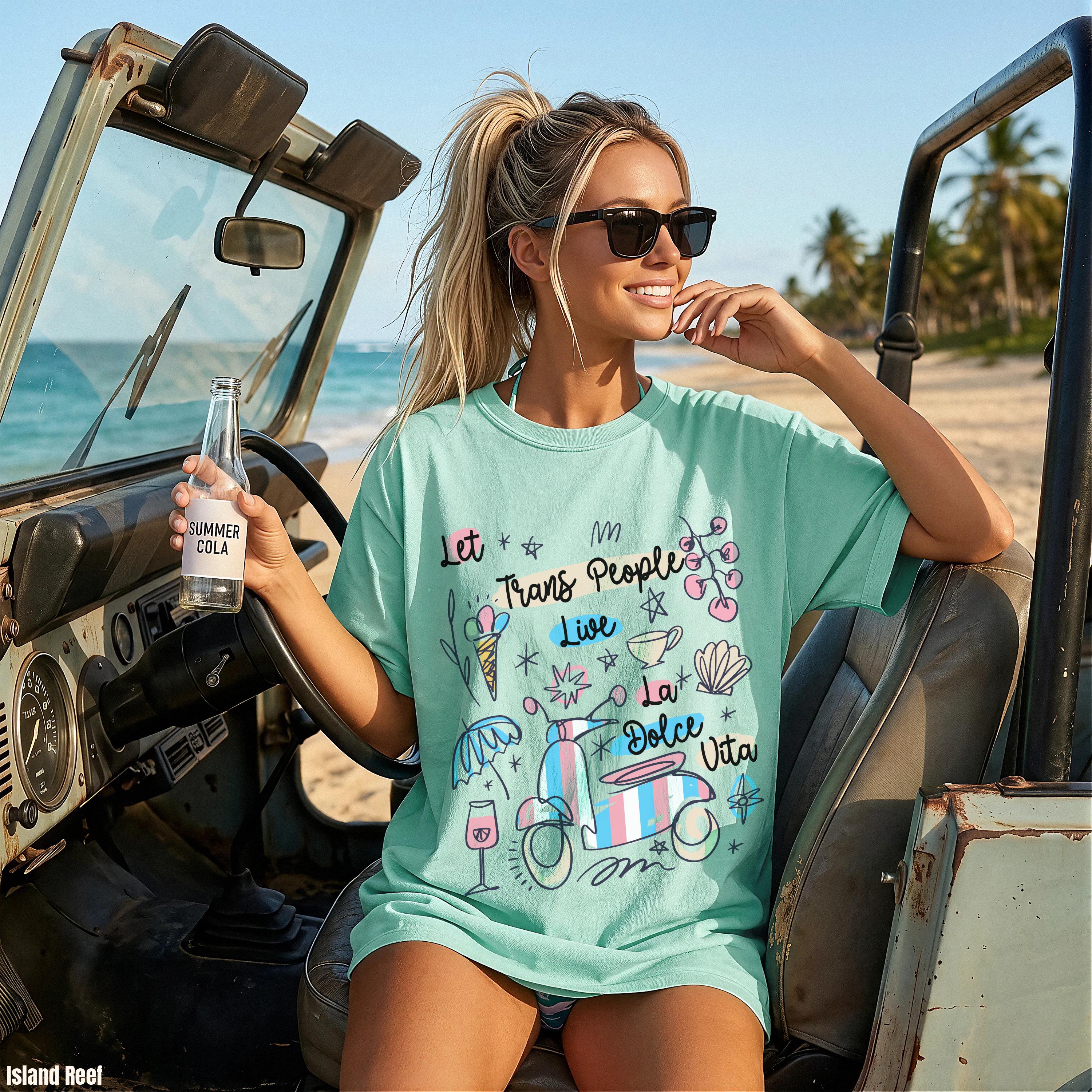 Teal t-shirt with "Trans Peoples Live" and "La Dolce Vita" text and graphics.