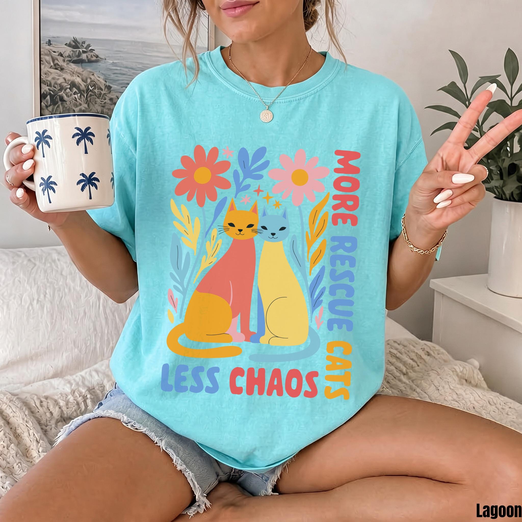 Two cats, pink and yellow, with text "MORE RESCUE CATS LESS CHAOS".