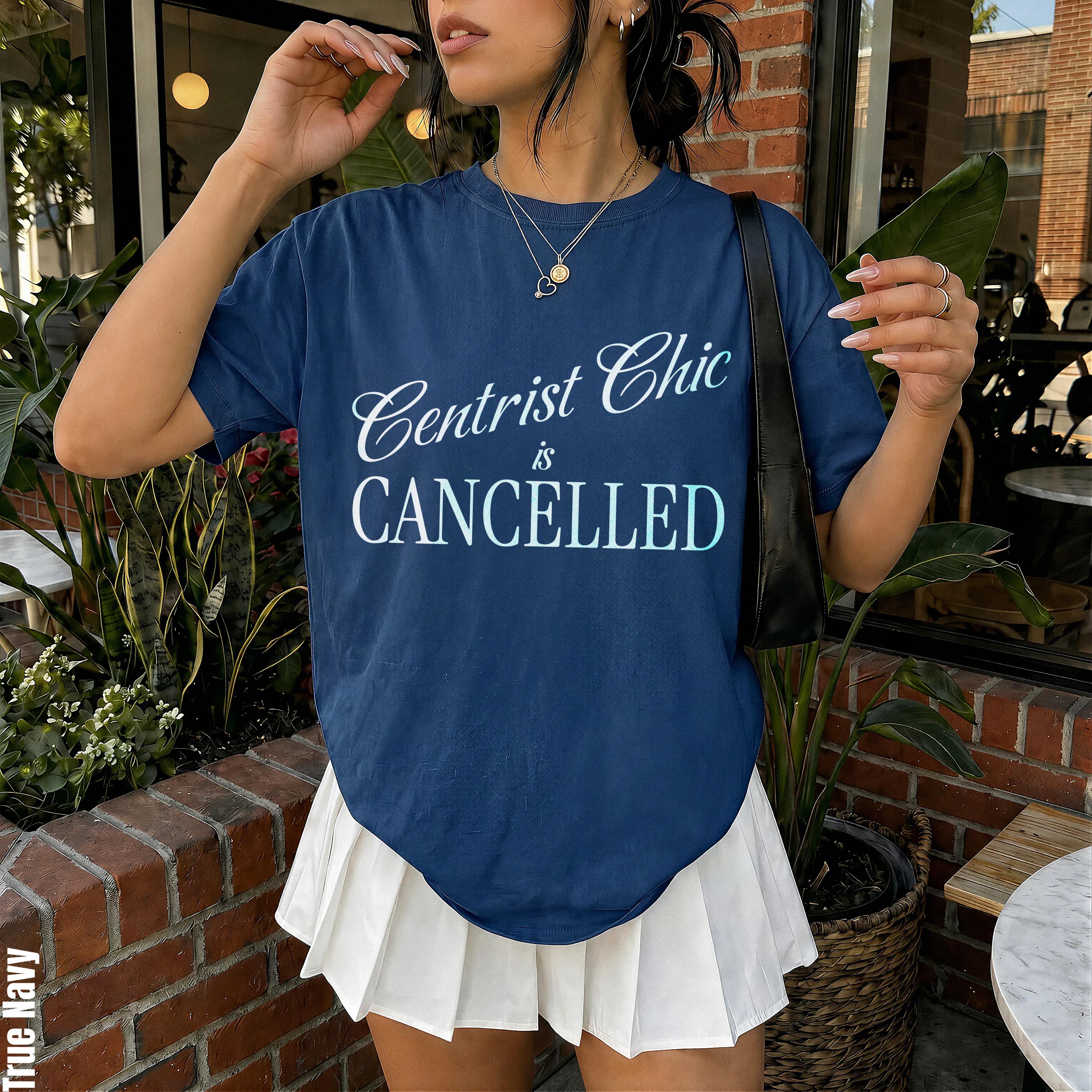 Dark blue t-shirt with "Centrist Chic is CANCELLED" graphic and white pleated skirt.