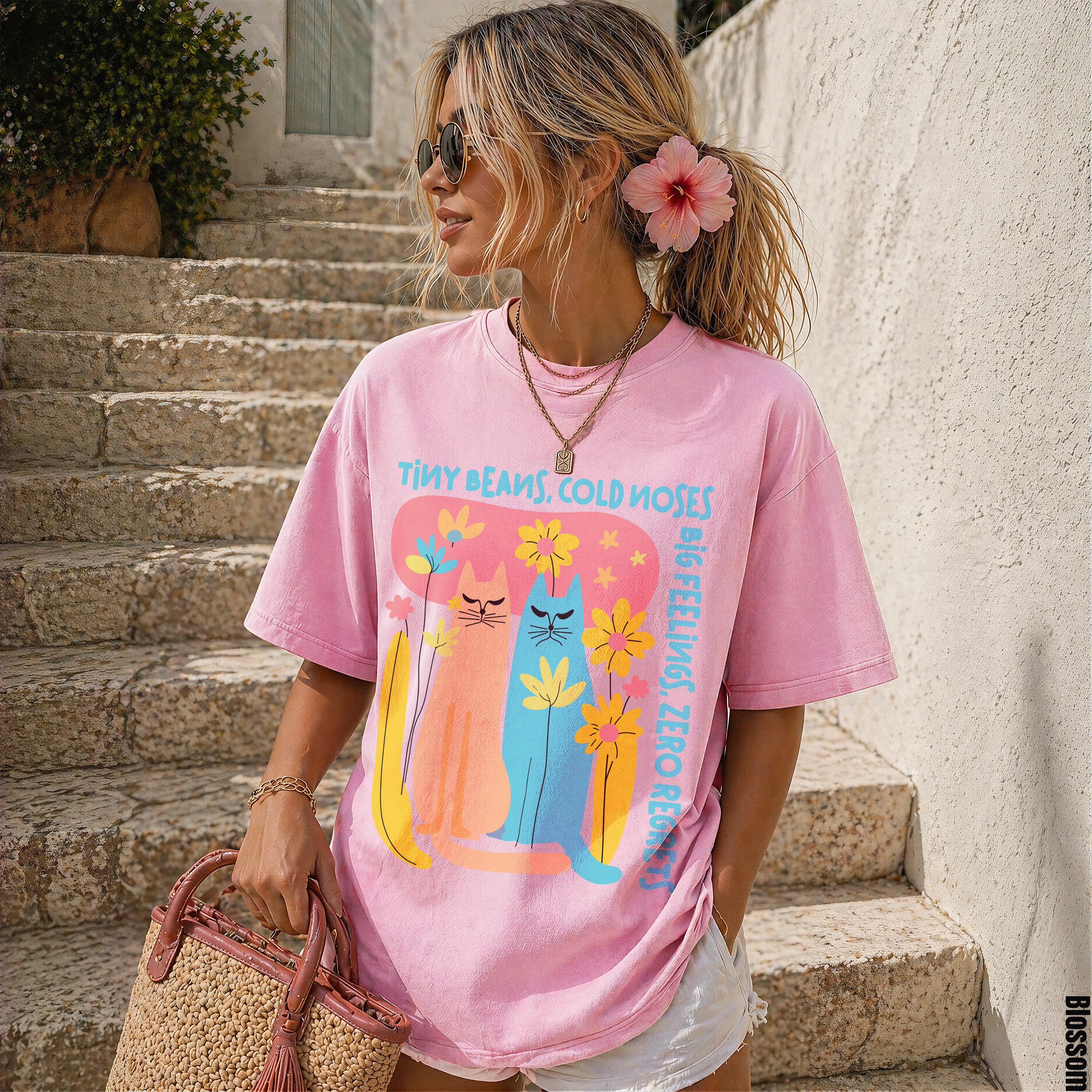 Pink t-shirt with "Tiny Beans, Cold Noses" text and three colorful cats graphic.