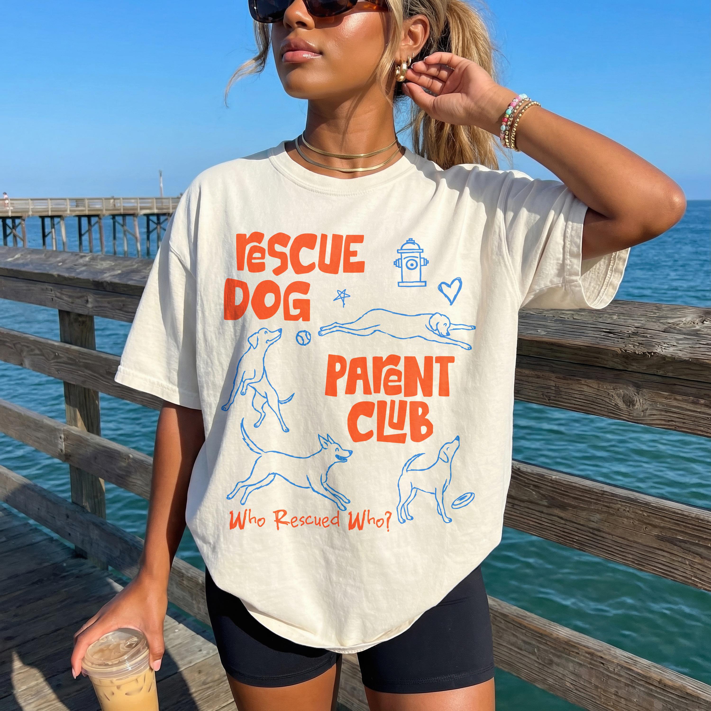 Cream t-shirt with "Rescue Dog Parent Club" text and dog illustrations.