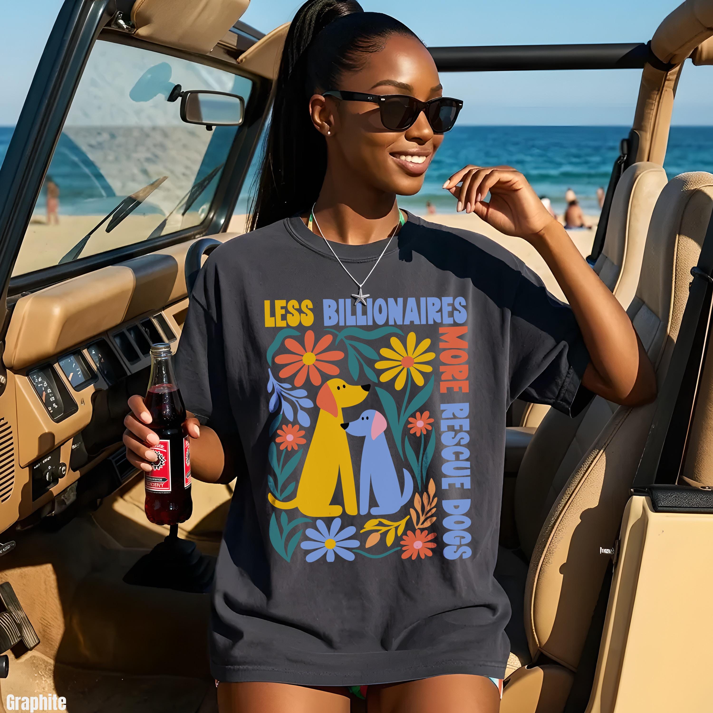 Woman in dark t-shirt with dogs and flowers graphic, holding drink.
