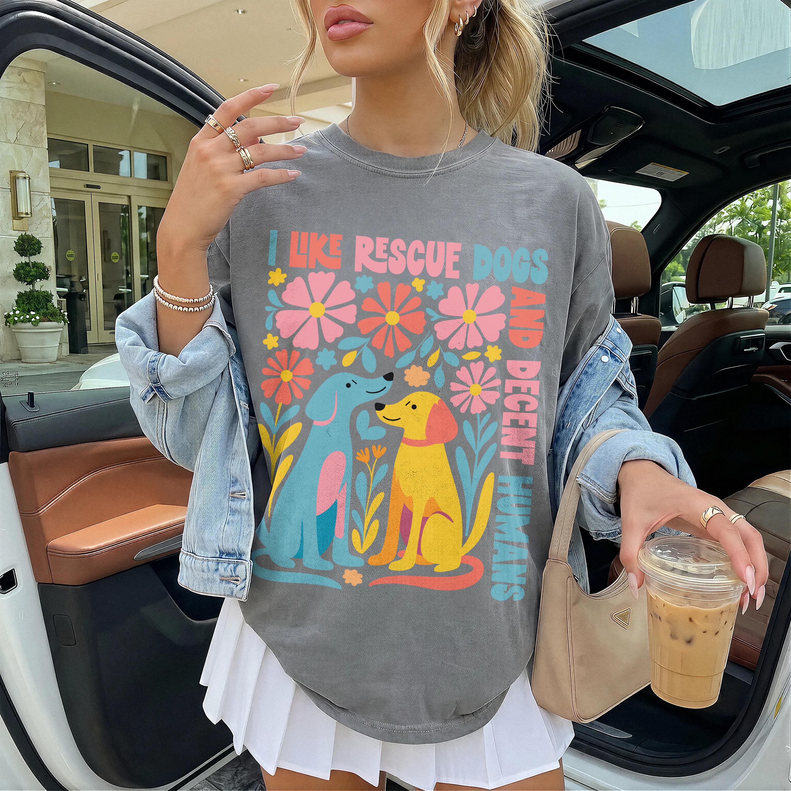 Graphic tee with "I like rescue dogs and decent humans" text and colorful dog and flower illustration.
