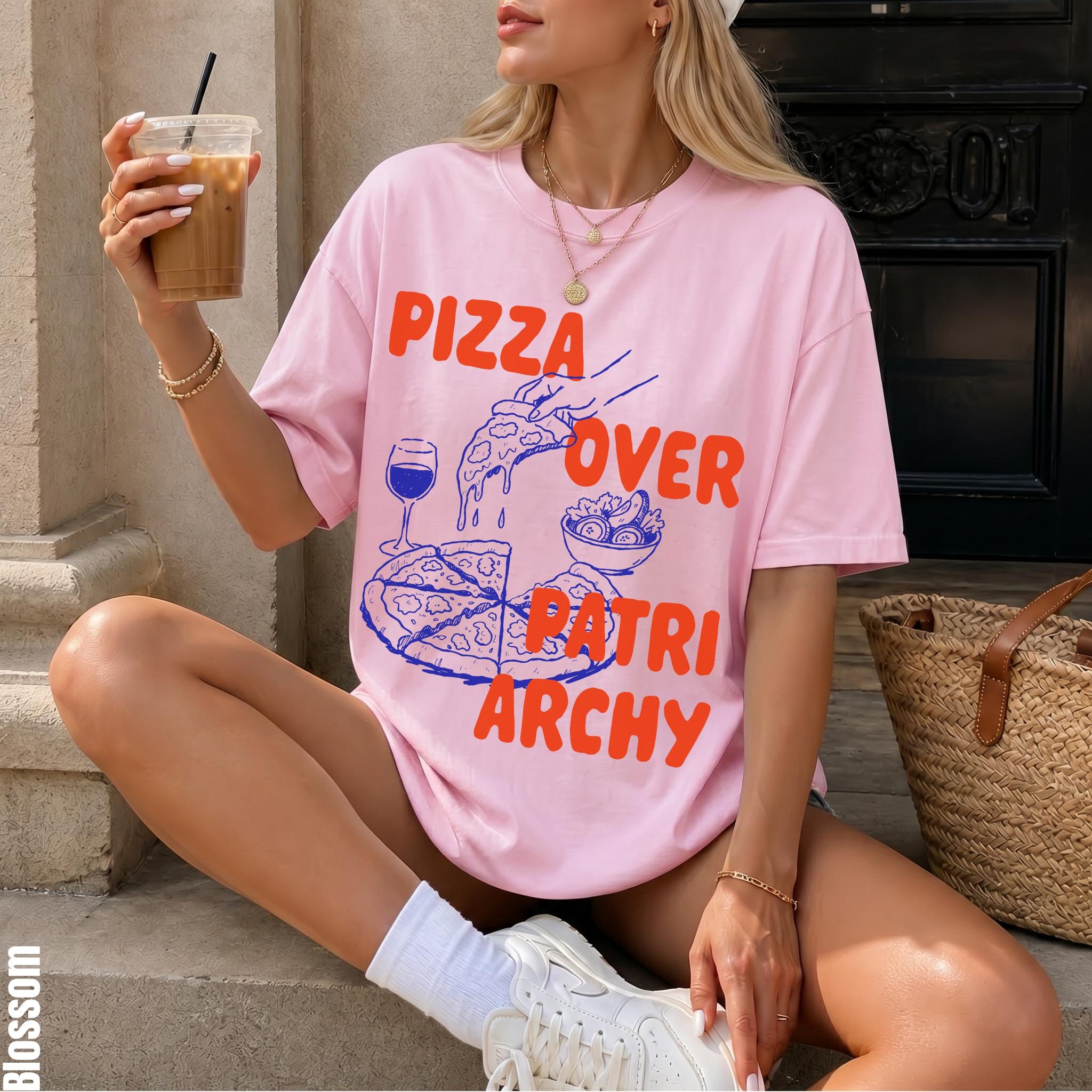 Pink t-shirt with "Pizza Over Patriarchy" graphic, featuring pizza, salad, and wine.