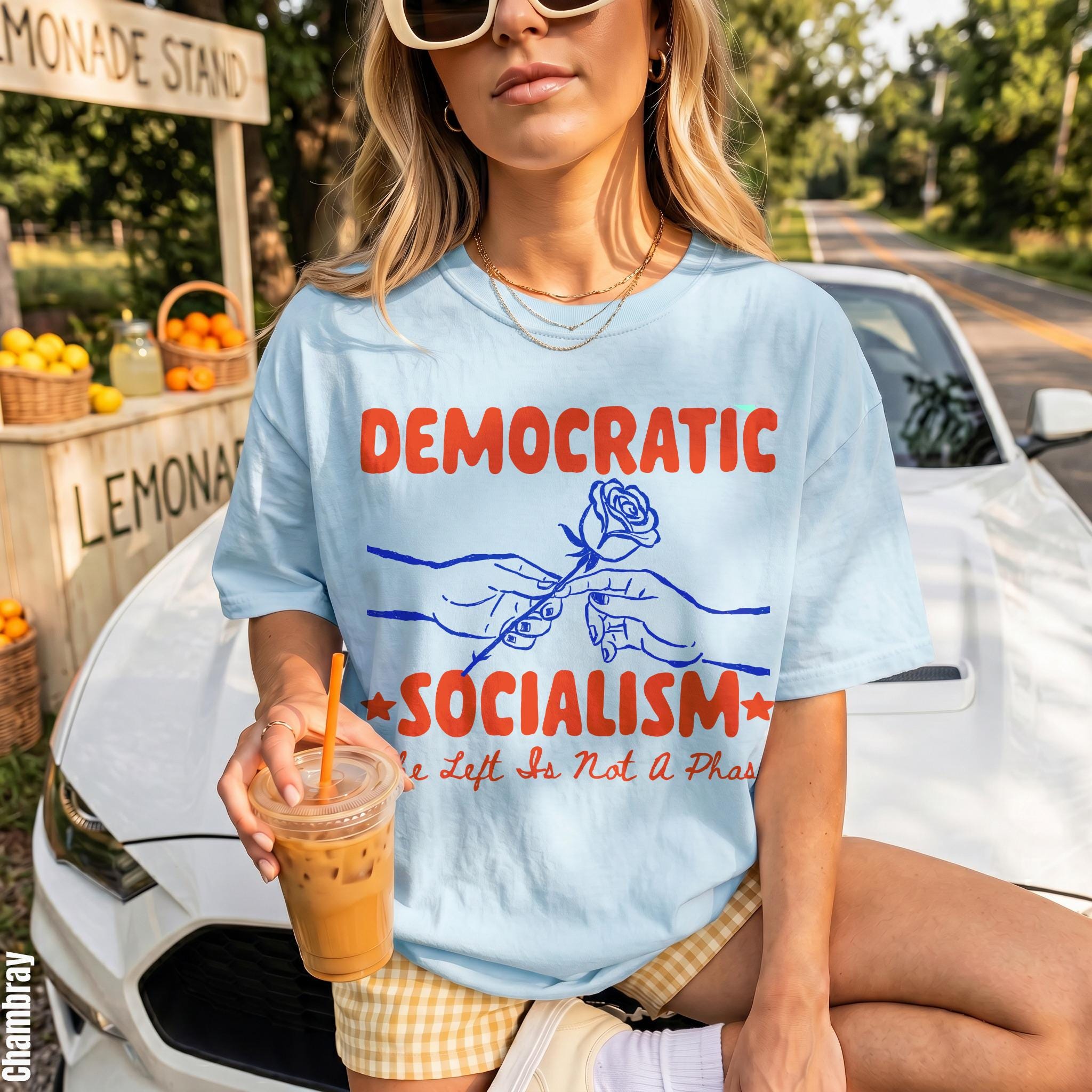 Light blue t-shirt with "Democratic Socialism" and a rose between hands graphic.