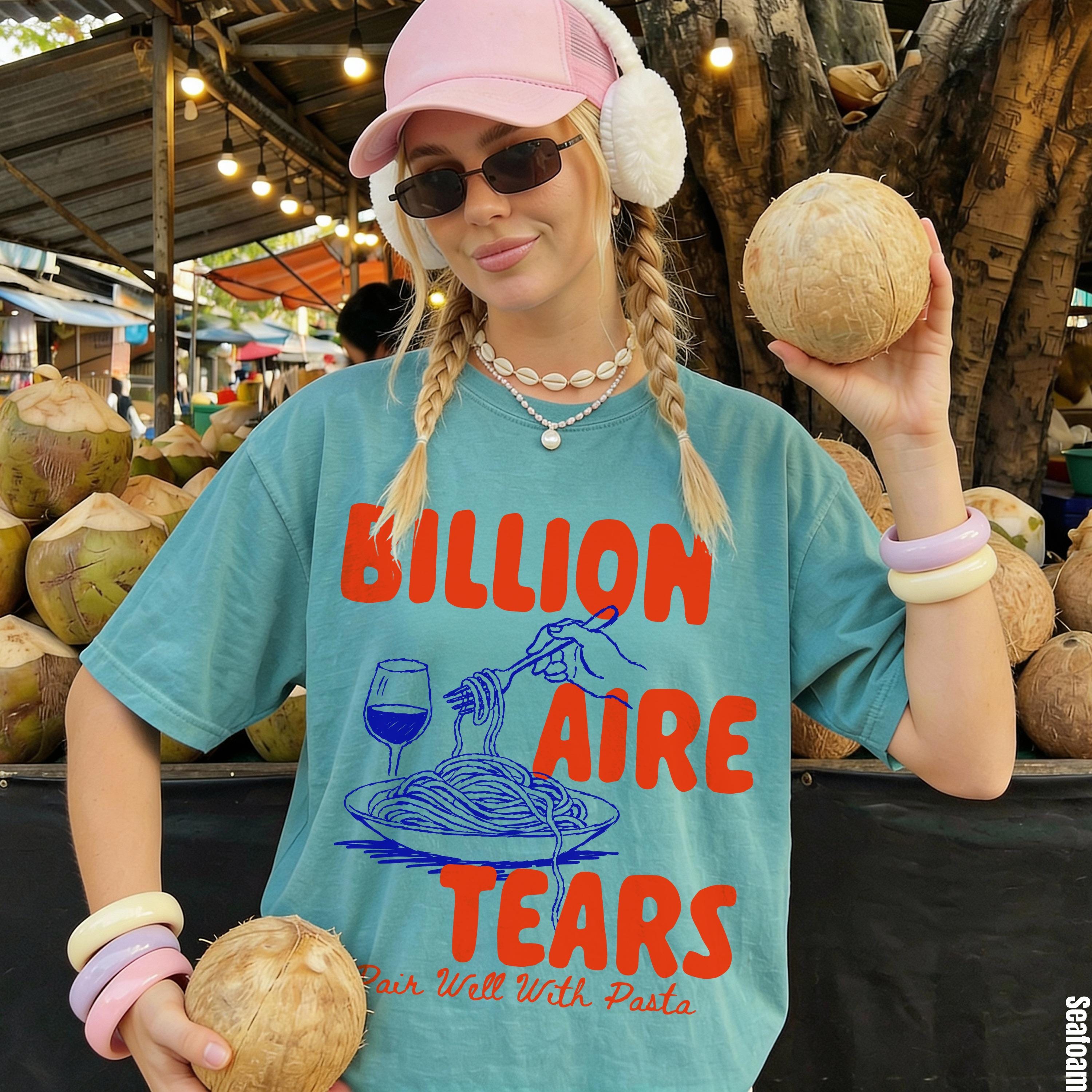 Teal t-shirt with "BillionAIRE TEARS Pair Well With Pasta" text and graphics.