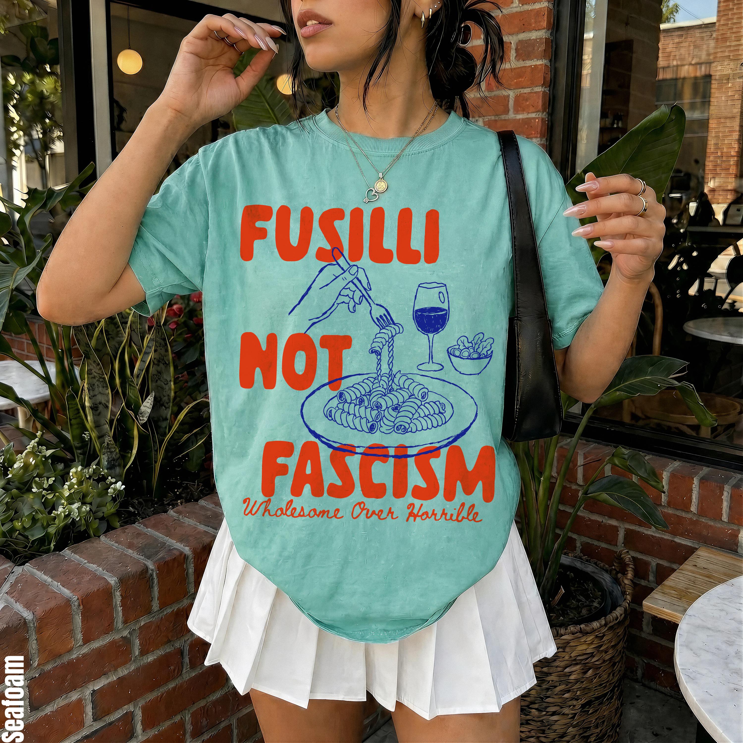 T-shirt with "Fusilli Not Fascism" graphic and pasta illustration.