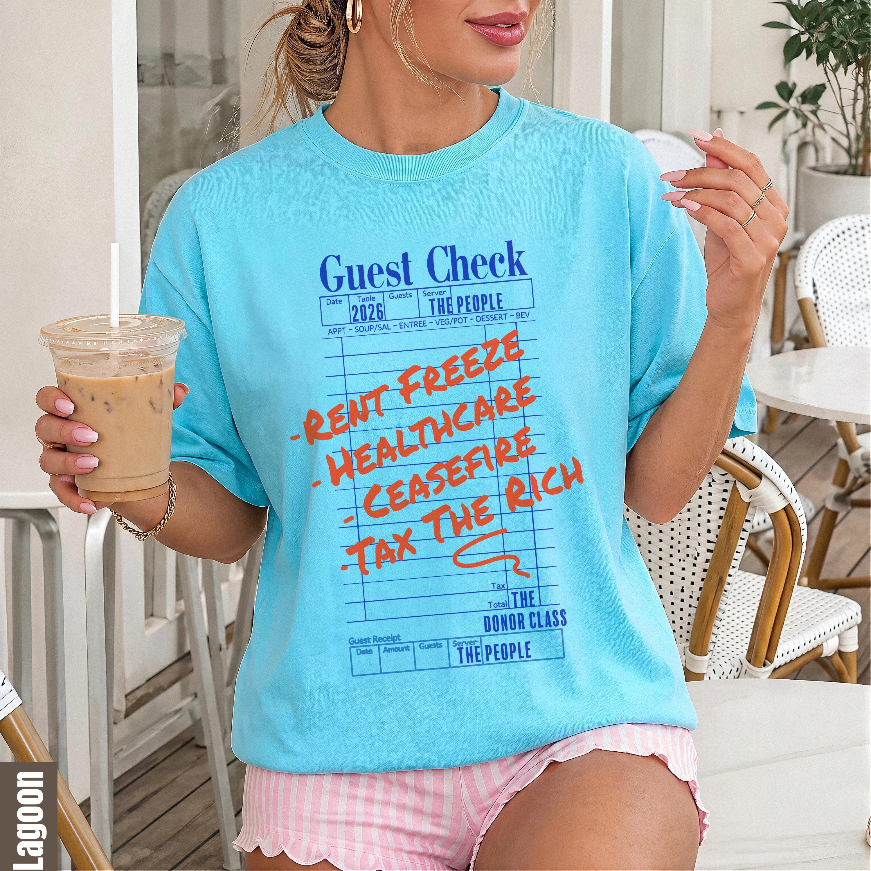 Bleached blue t-shirt with "Guest Check" graphic featuring "Rent Freeze," "Healthcare," "Ceasefire," and "Tax The Rich."