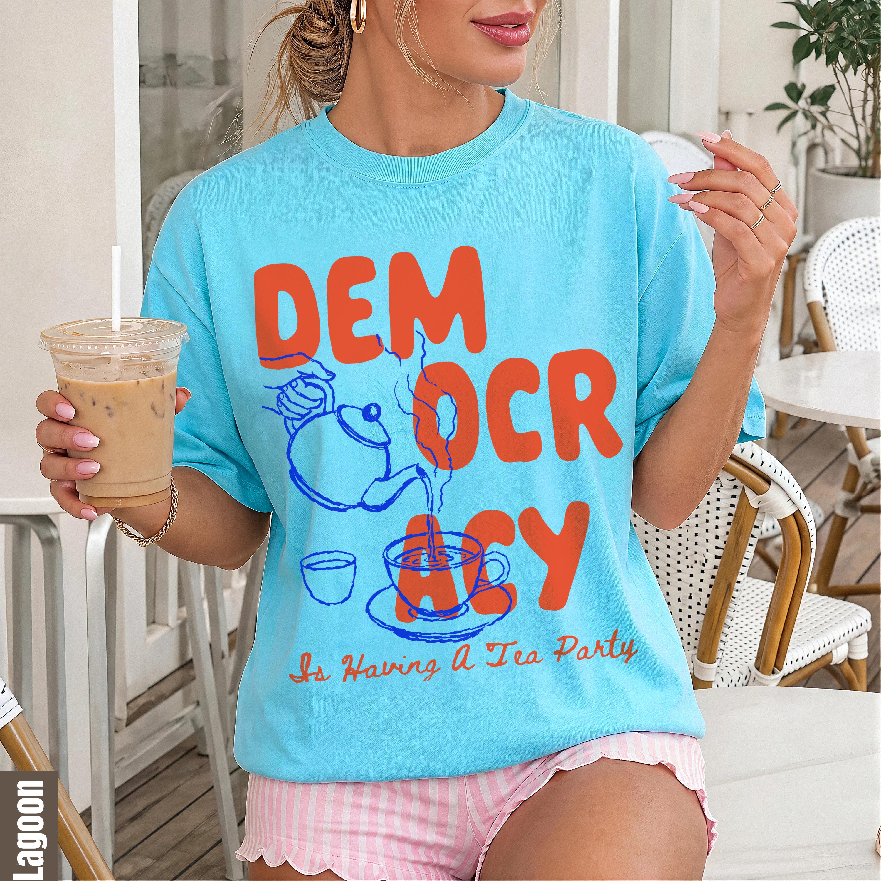 Light blue t-shirt with "Democracy Is Having A Tea Party" graphic and blue outline sketch.