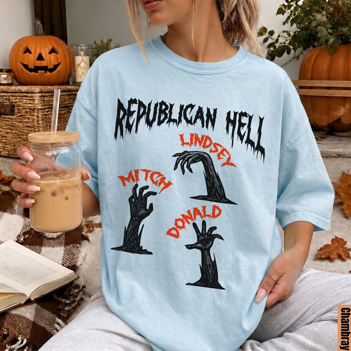 Light blue t-shirt with black and red text and graphics of zombie hands.