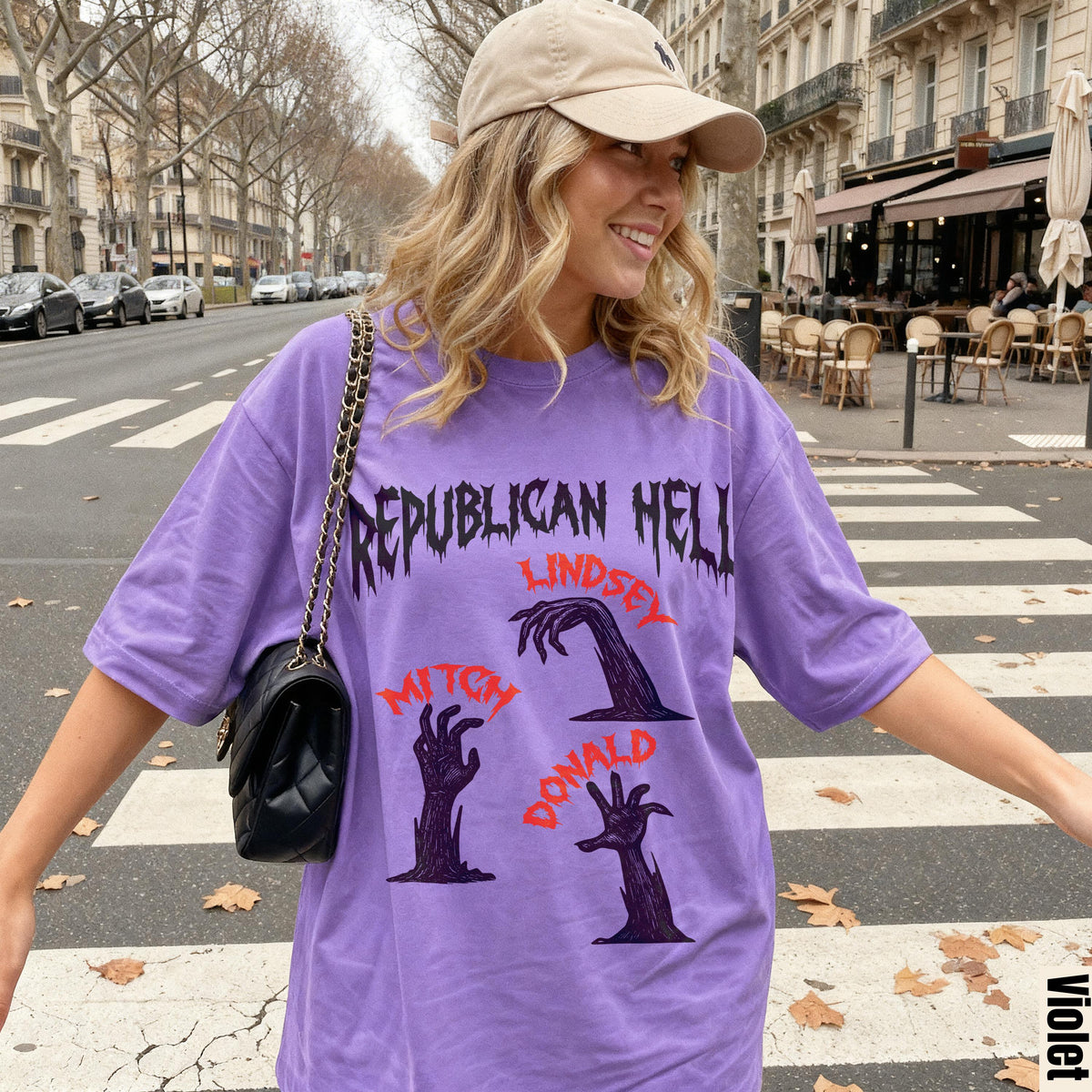 Woman wearing purple t-shirt with "Republican Hell" and zombie hands print.