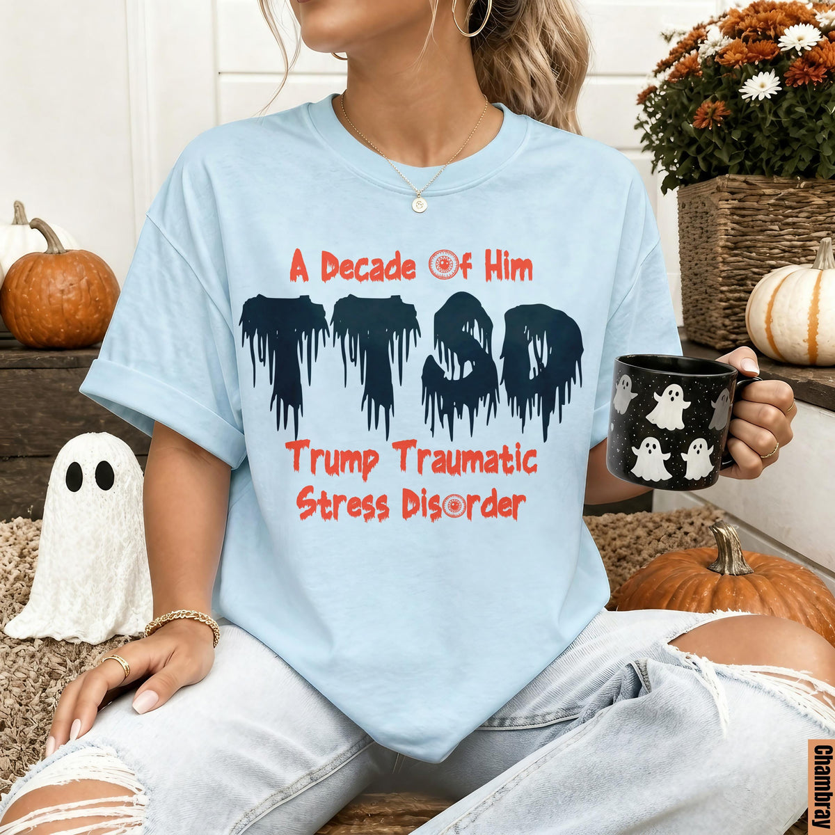 Light blue t-shirt with "A Decade of Him" and "Trump Traumatic Stress Disorder" text.