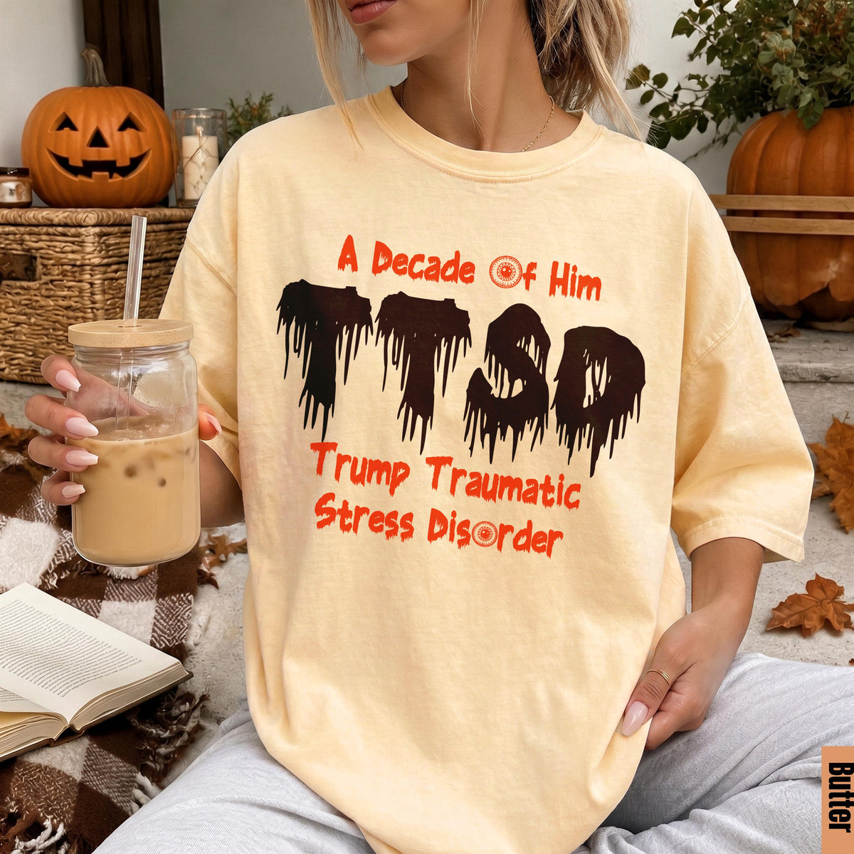 Yellow t-shirt with "A Decade Of Him" and "Trump Traumatic Stress Disorder" text.