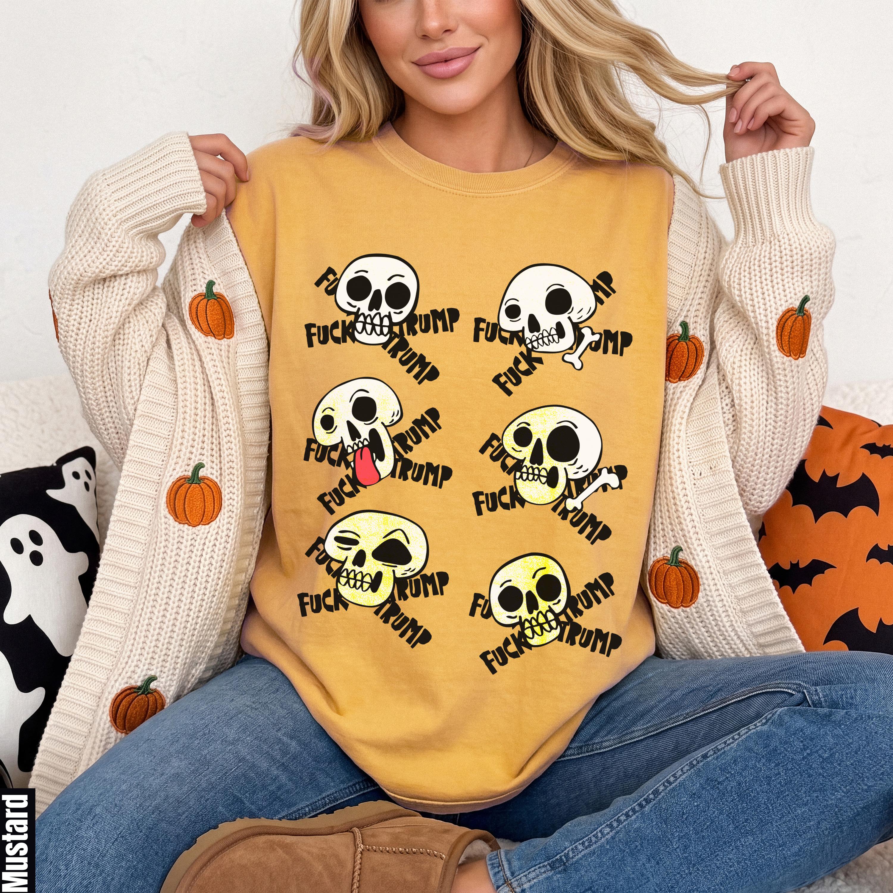 Mustard yellow sweatshirt with repeated skull graphic and text.