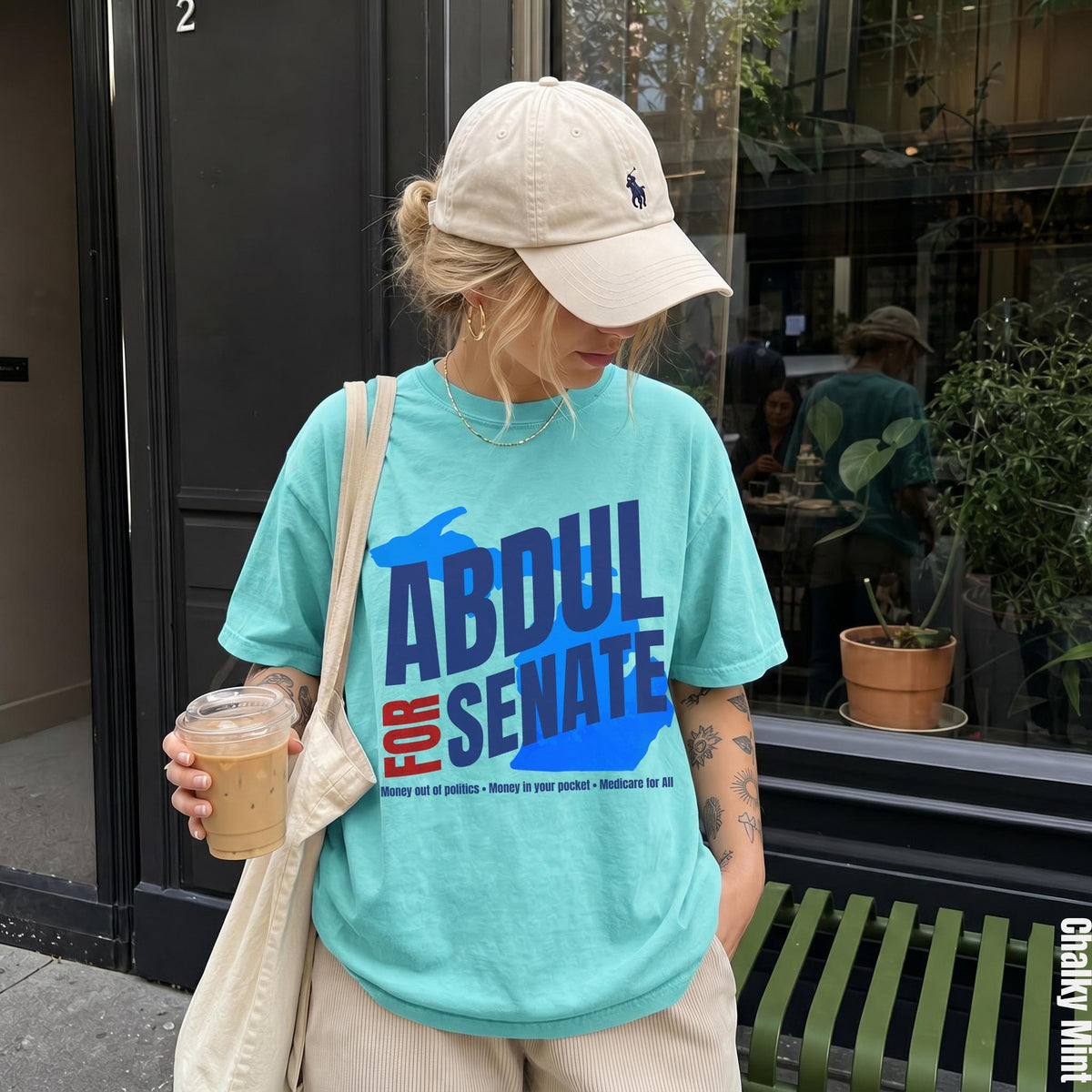 Turquoise t-shirt with "ABDUL FOR SENATE" text and campaign slogans.