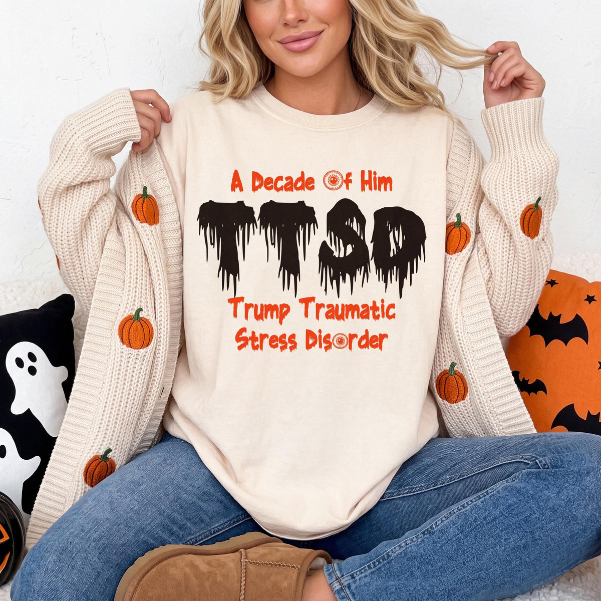 Cream sweatshirt with "A Decade Of Him TTSD Trump Traumatic Stress Disorder" text, pumpkin cardigan