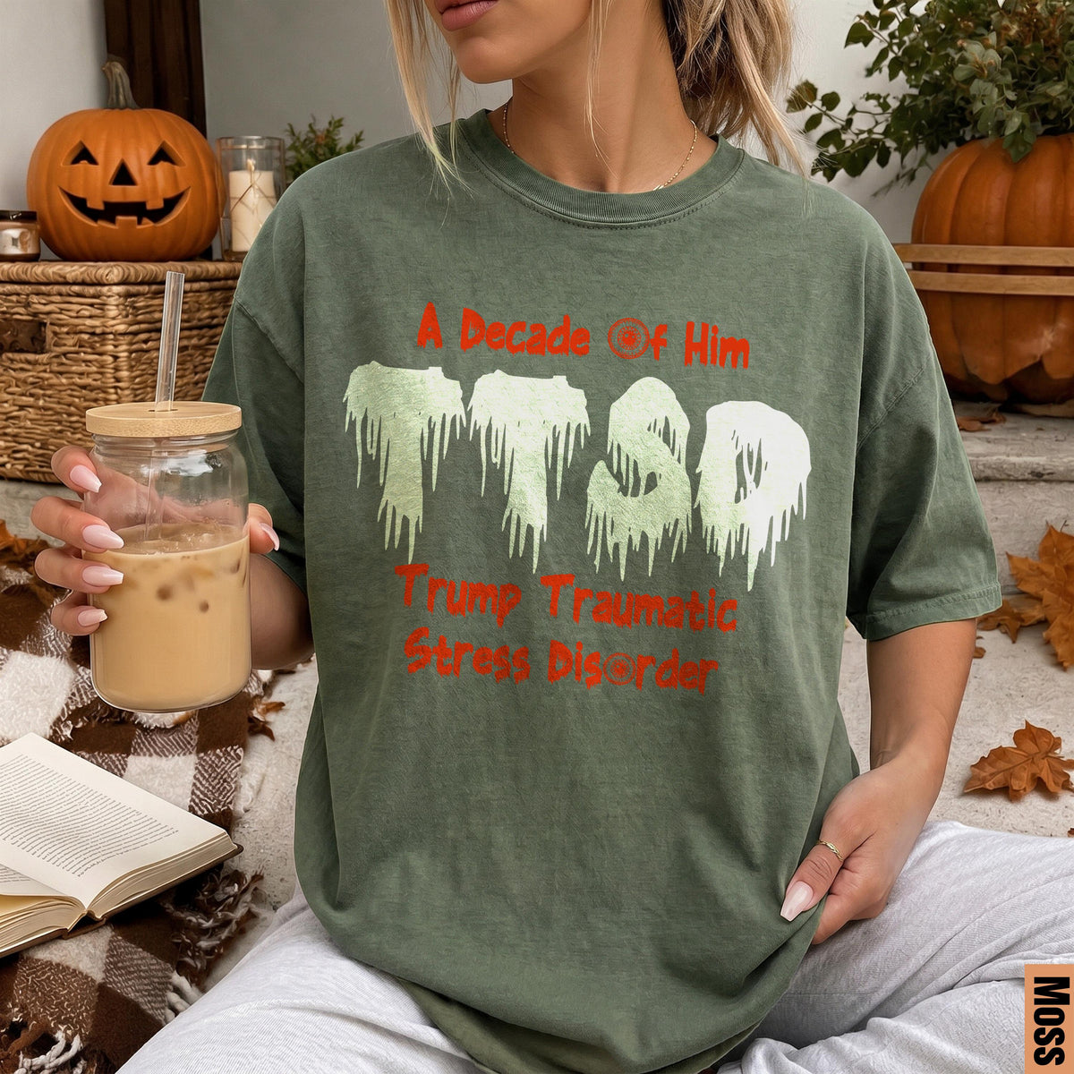 Green t-shirt with "A Decade of Him Trump Traumatic Stress Disorder" text.