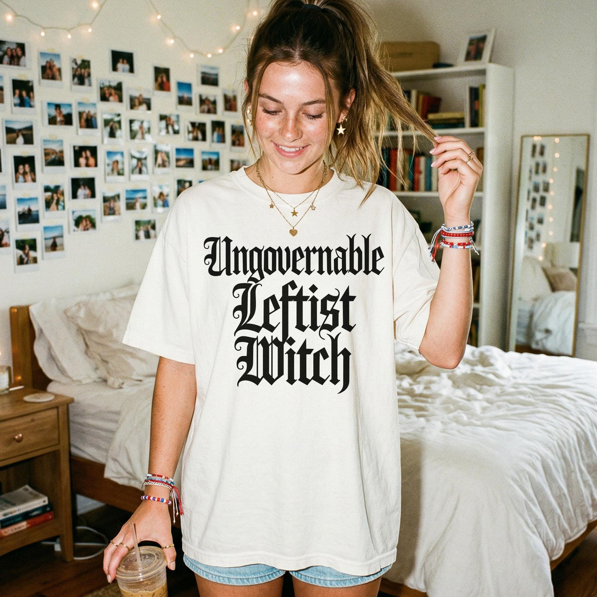 Cream t-shirt with "Ungovernable Leftist Witch" text, worn by a young woman.