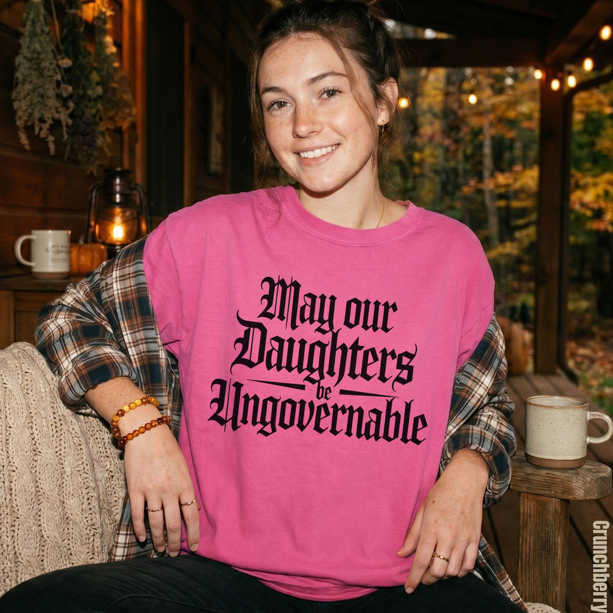 Pink sweatshirt with "May our Daughters be Ungovernable" in gothic font.