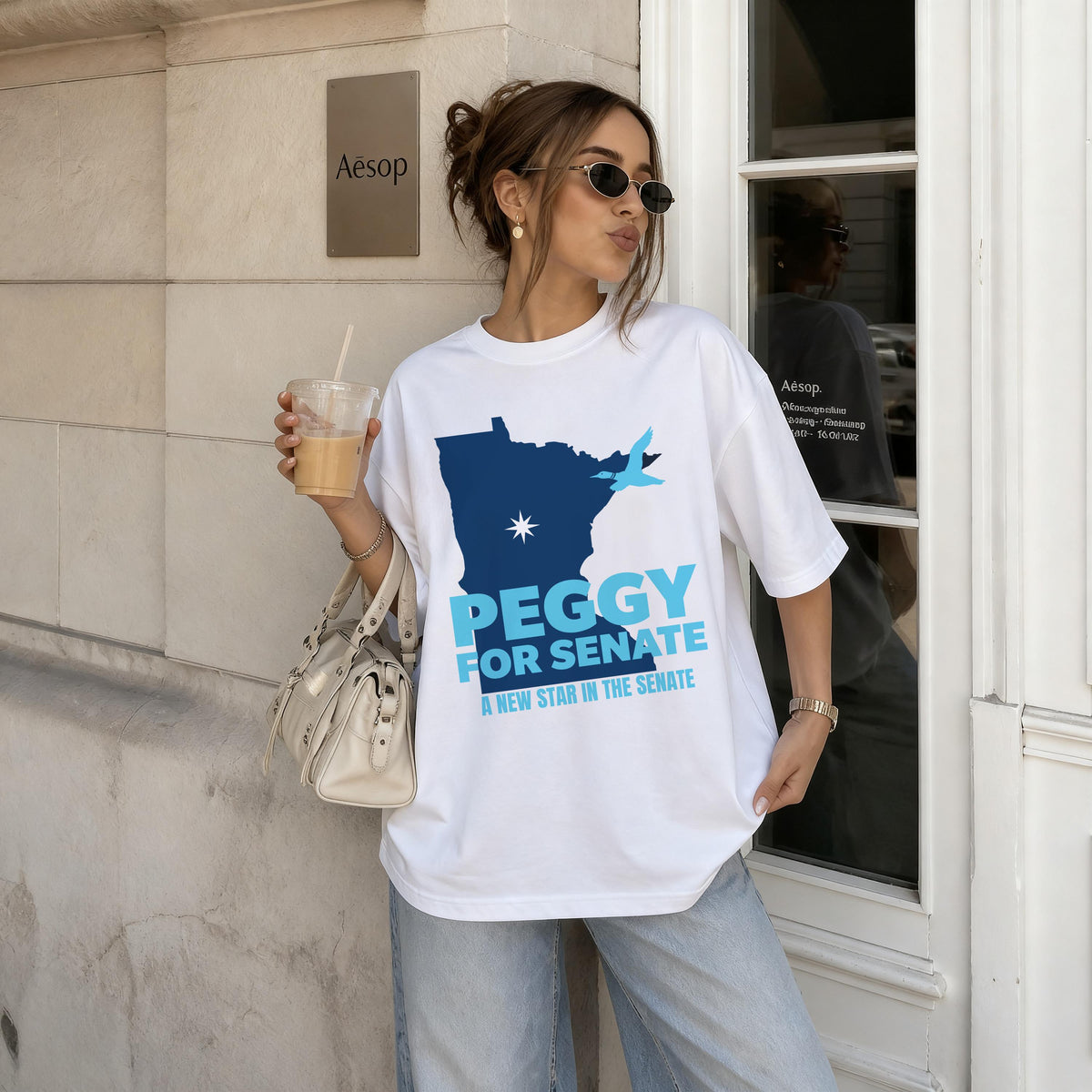 White t-shirt with blue "Peggy for Senate" text and map graphic.